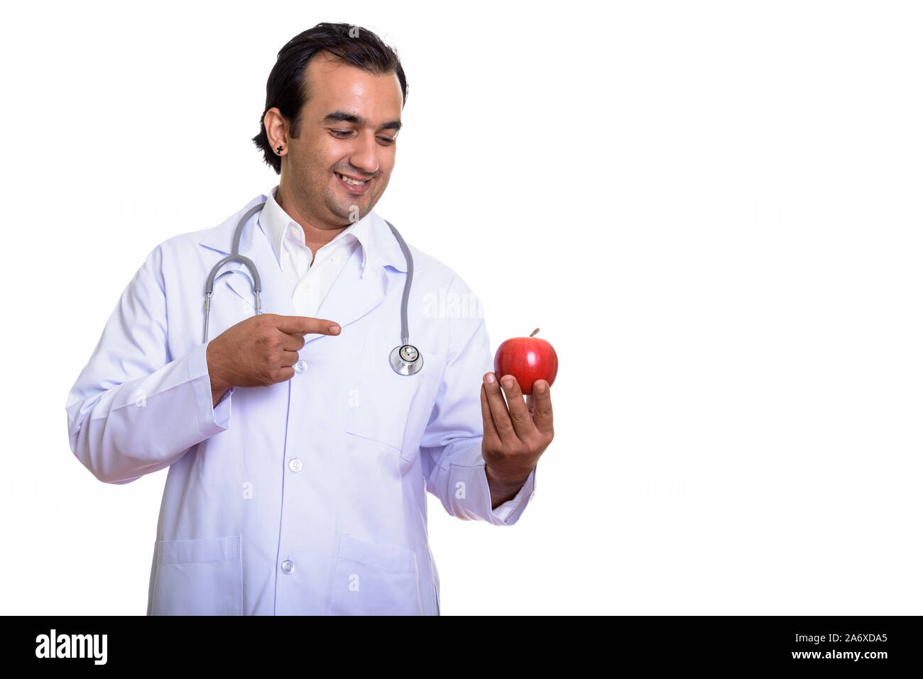 Portrait of happy Persian man doctor with red apple Stock Photo