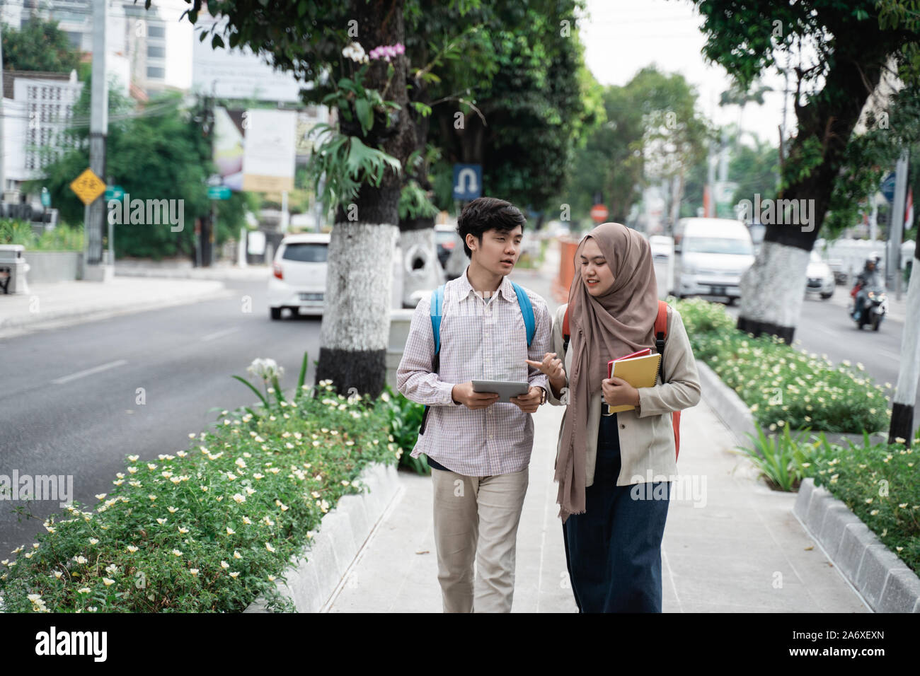 two asian student walking together go to campus Stock Photo - Alamy