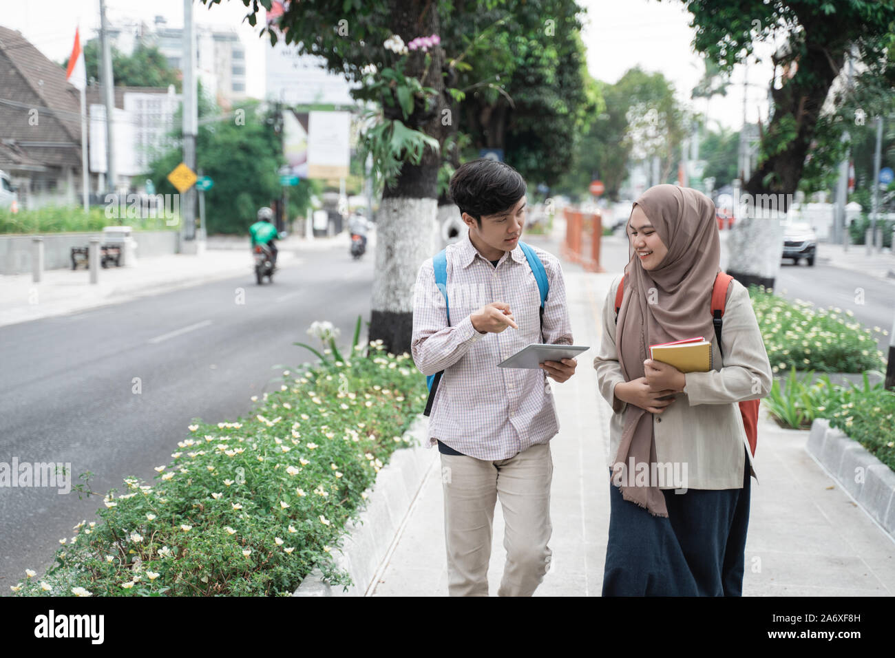 two asian student walking together go to campus Stock Photo - Alamy