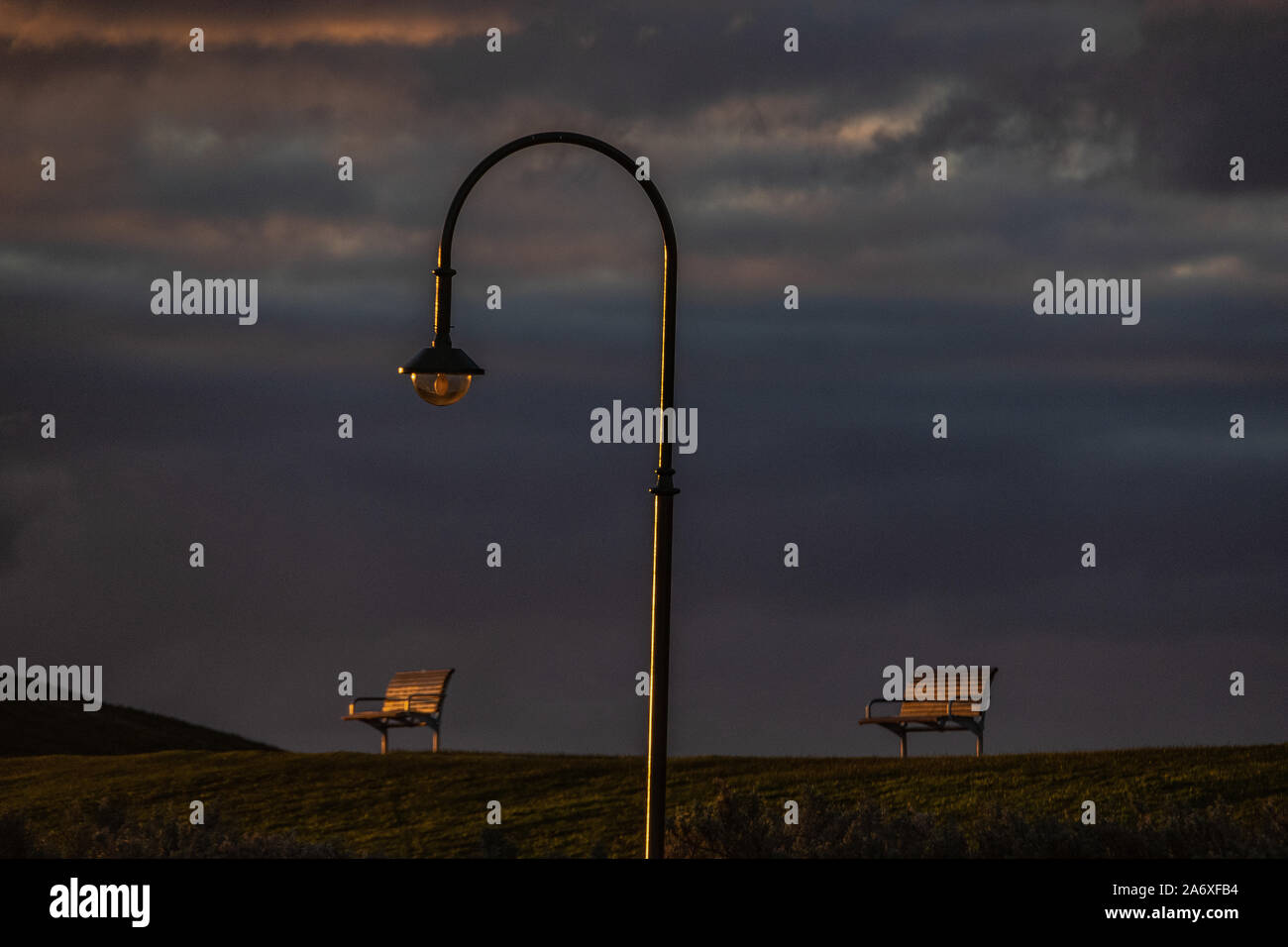 Empty park benches and street lamp in the Melbourne suburb of Elwood. Stock Photo