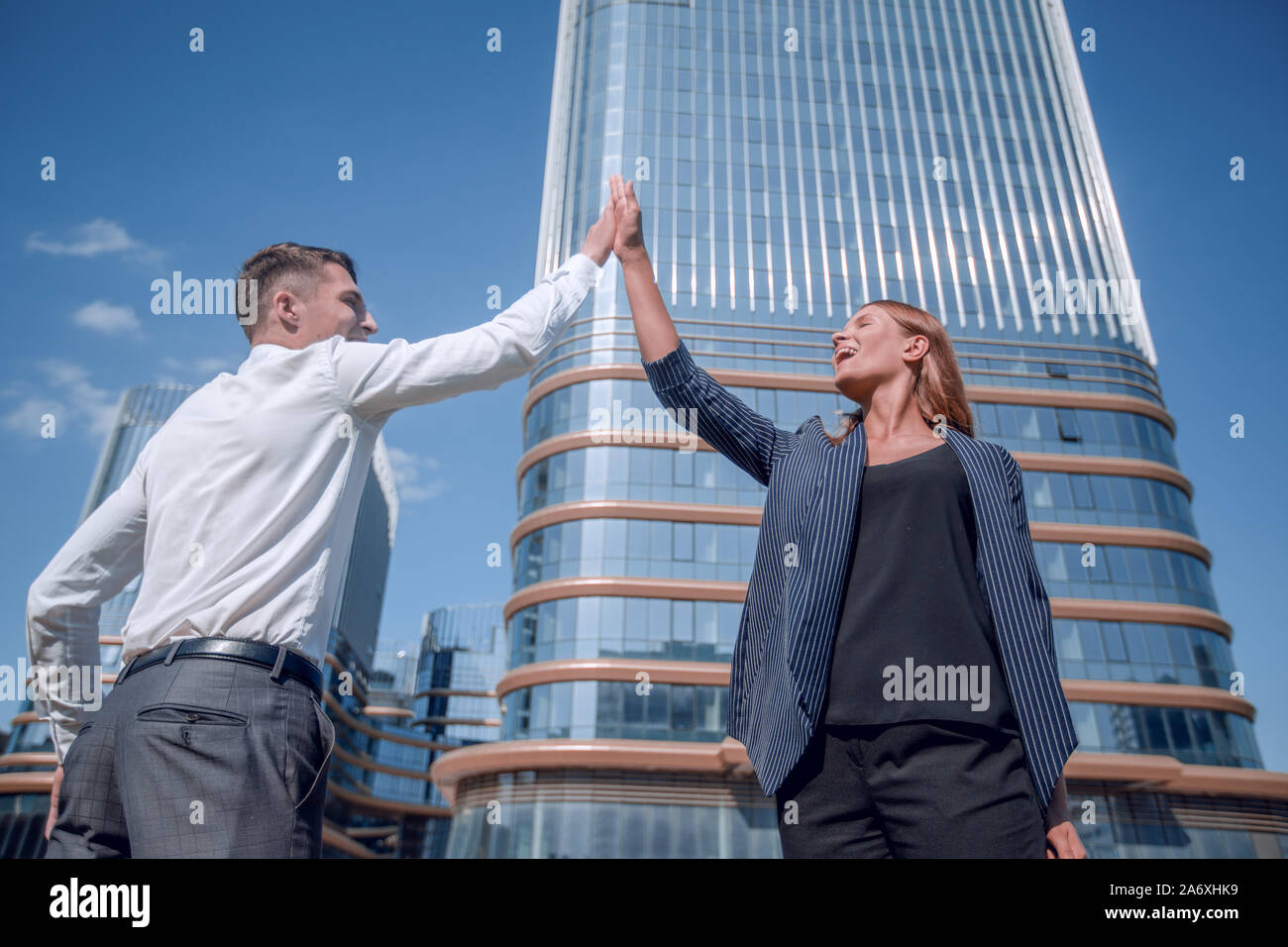 happy business colleagues giving each other a high five Stock Photo - Alamy