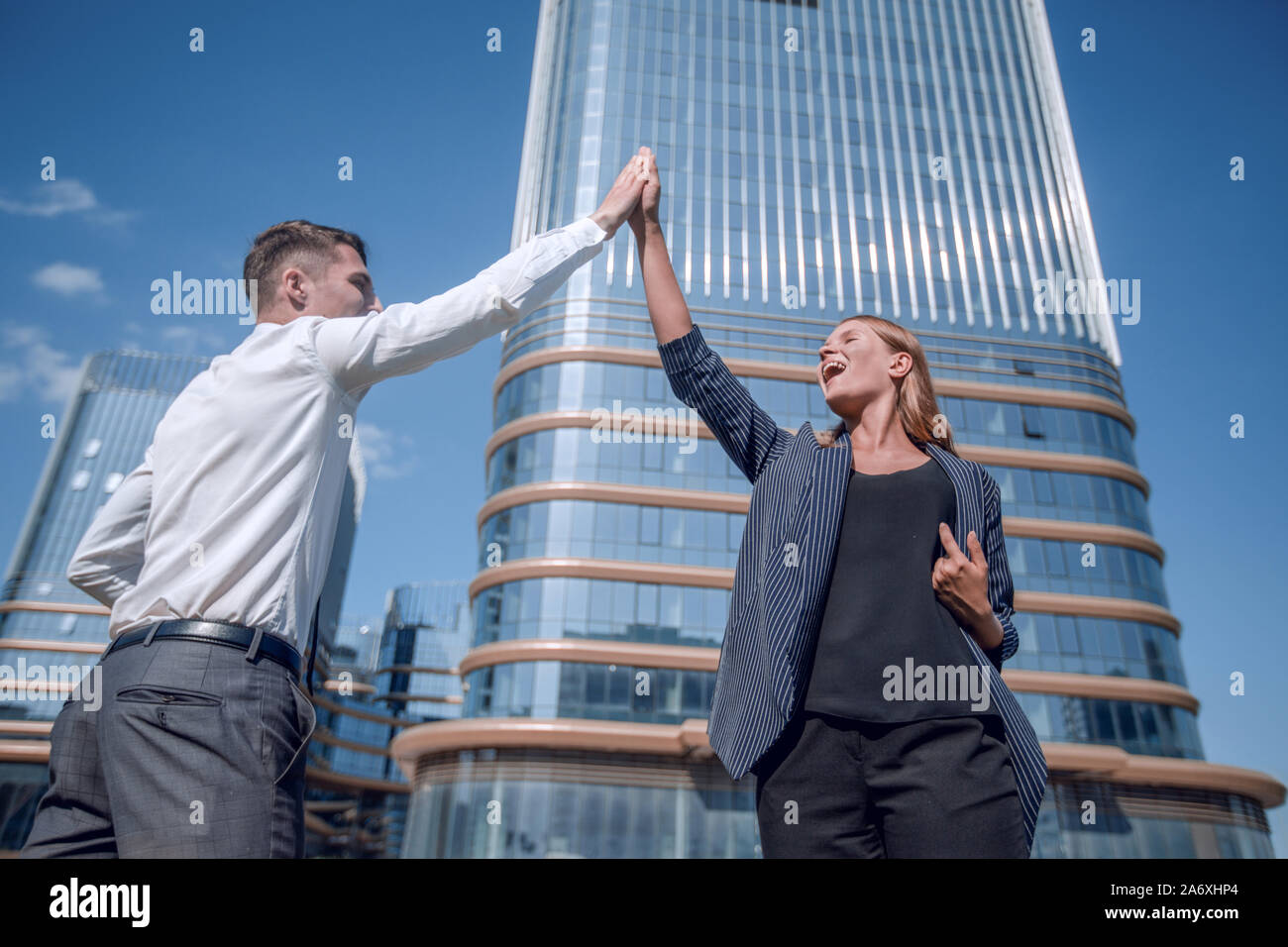 happy business colleagues giving each other a high five Stock Photo - Alamy