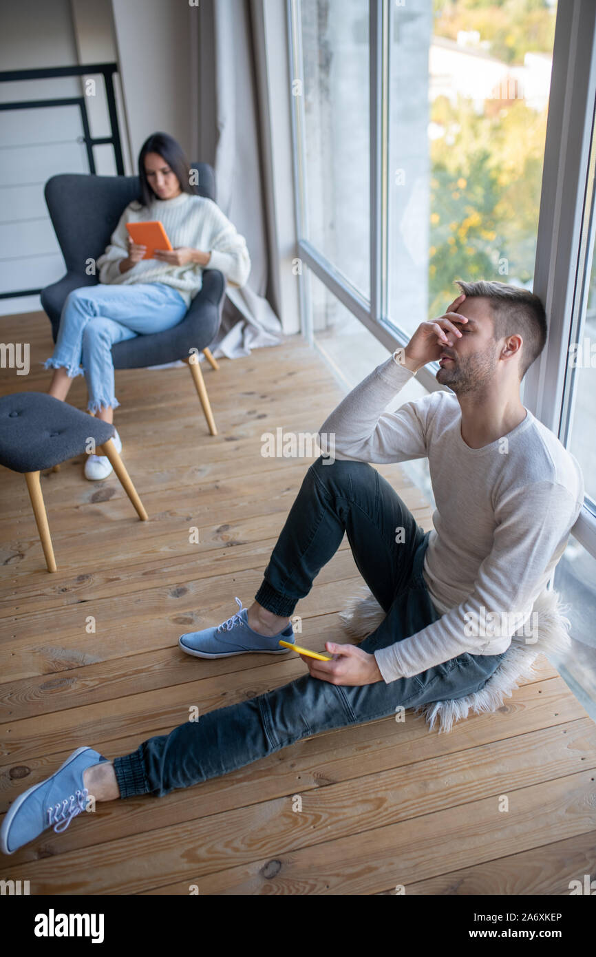 Top view of husband having headache after argument with wife Stock Photo