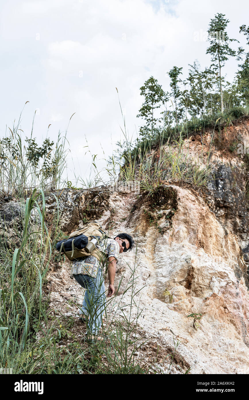 Man climbing through rock hi-res stock photography and images - Alamy