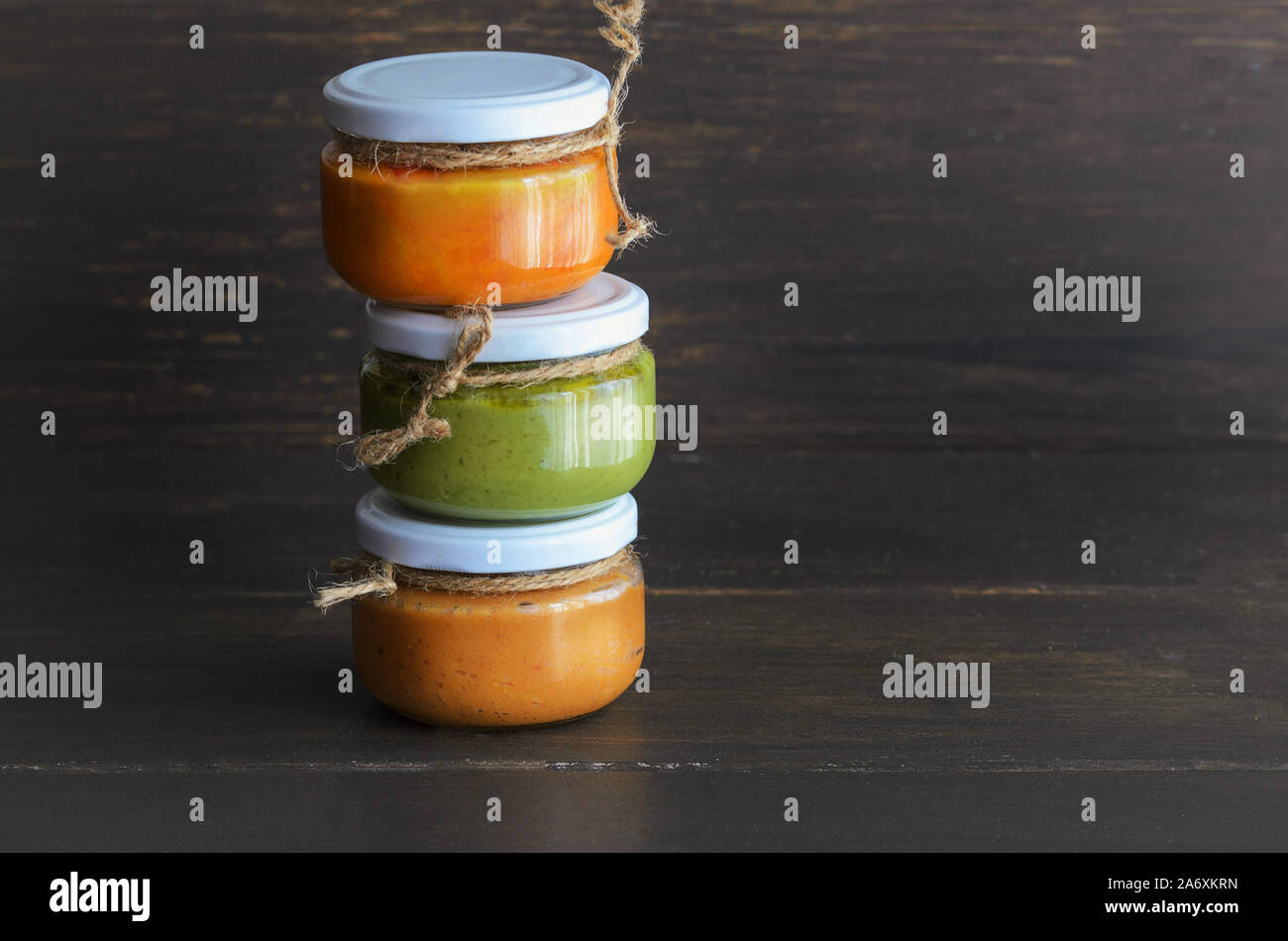 Several types of typical Canary Islands sauces in glass jar: Mojo picon, mojo verde  made and almogrote are popular souvenirs of the fun holiday exper Stock Photo
