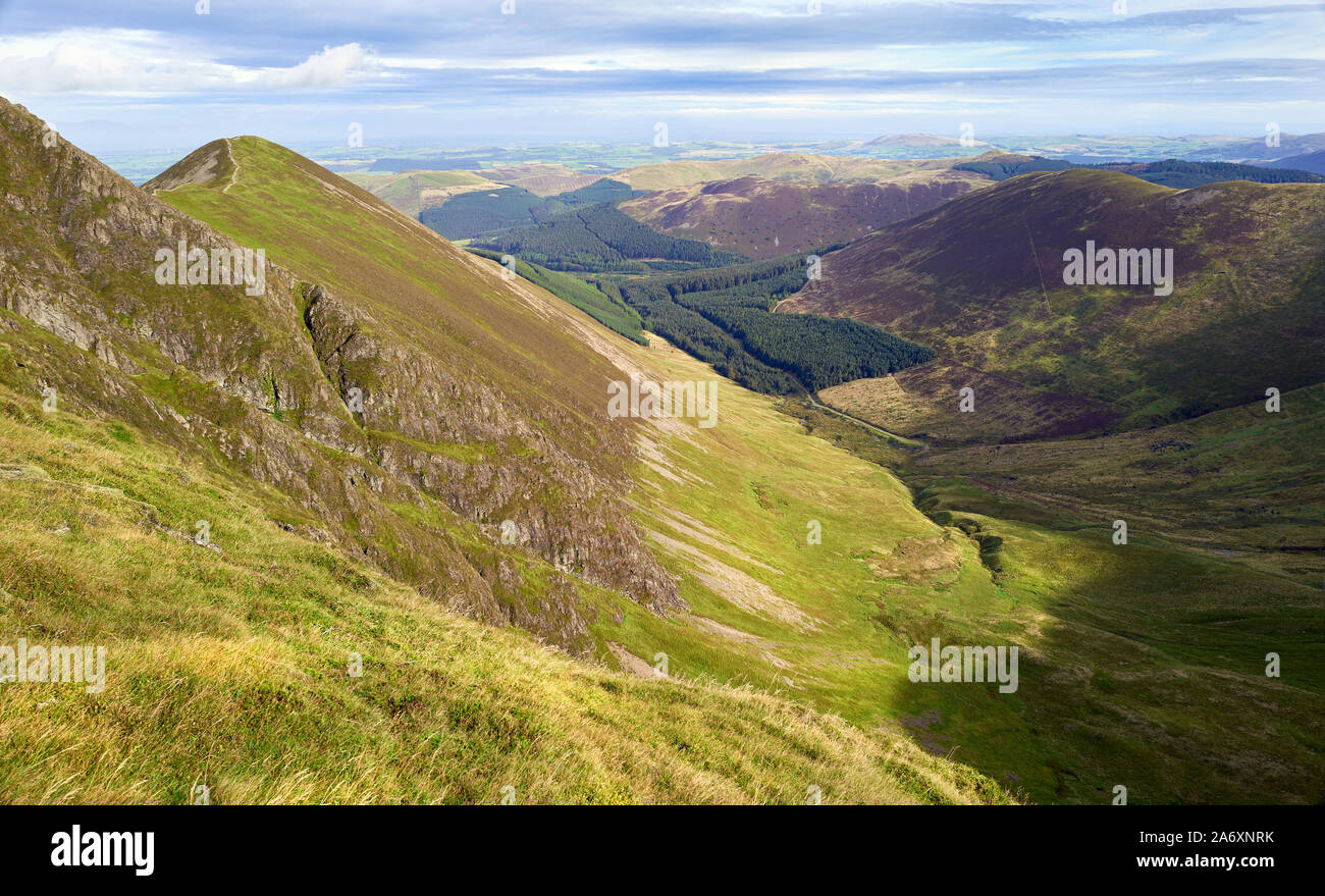 The summit of Ladyside Pike and valley of Hobcarton Plantation on a sunny day in the Lake District, England, UK. Stock Photo