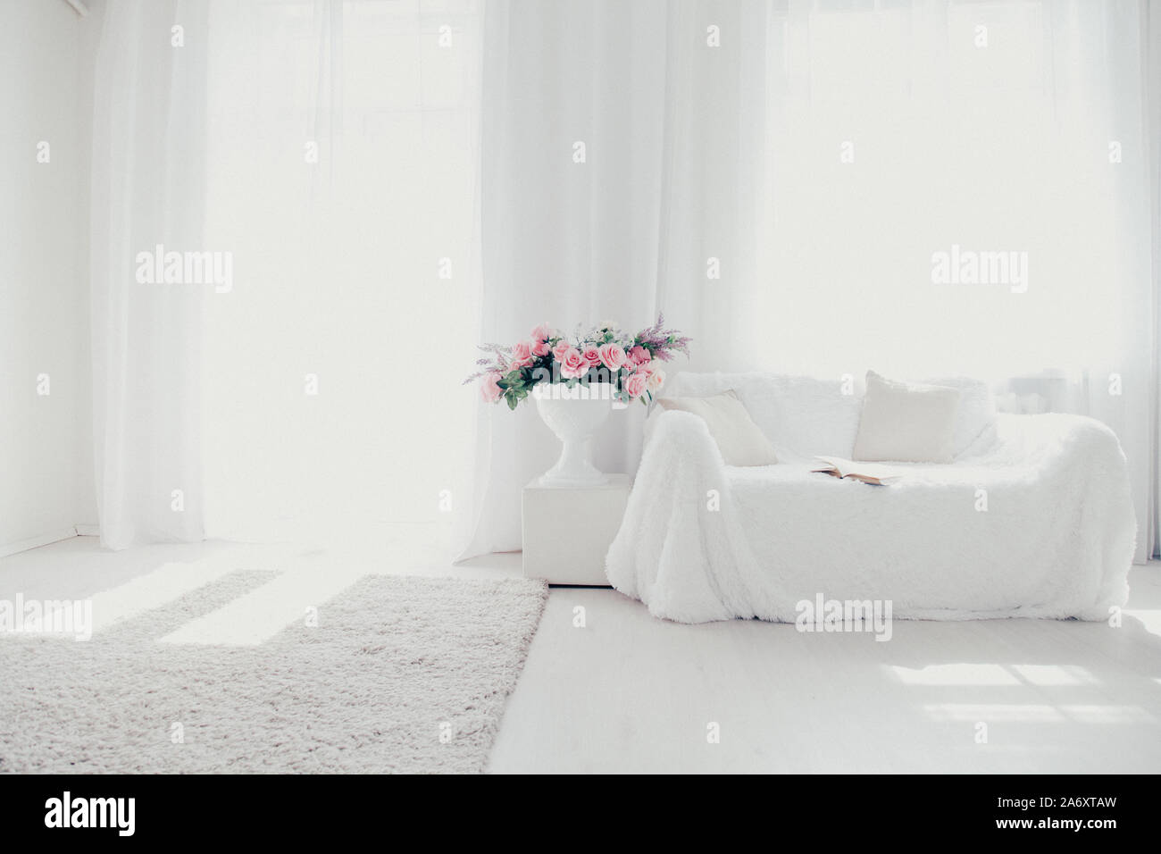 White lounge sofa large Windows and color book Stock Photo Alamy