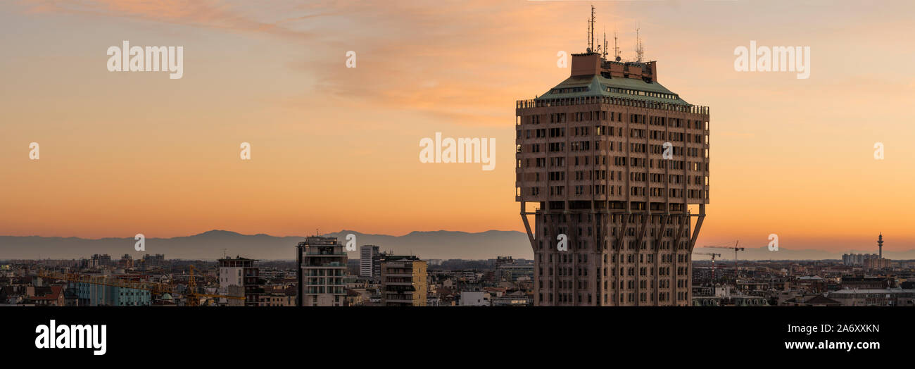 Milan, Italy: Urban landscape at sunset. Milan skyline with Velasca Tower (Torre Velasca). This famous skyscraper was built in the fifties. Stock Photo