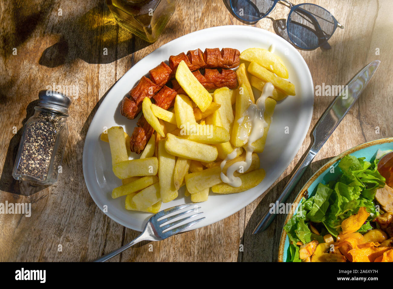 fast food in an outdoor cafe on a wooden table Stock Photo