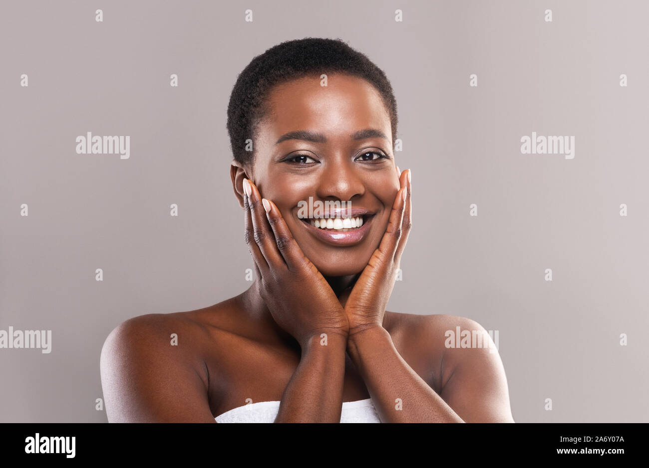 Beautiful black woman touching her face with perfect smooth skin Stock ...