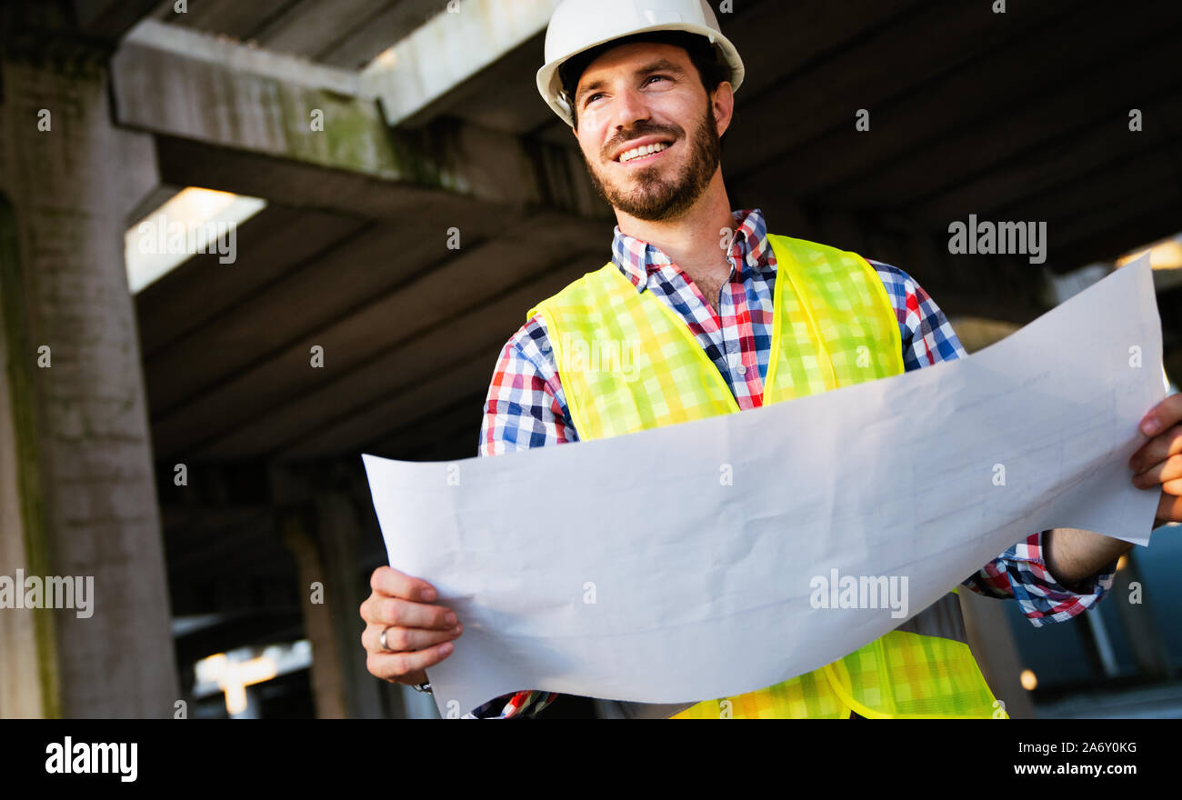 Picture of construction site engineer looking at blueprint Stock Photo ...