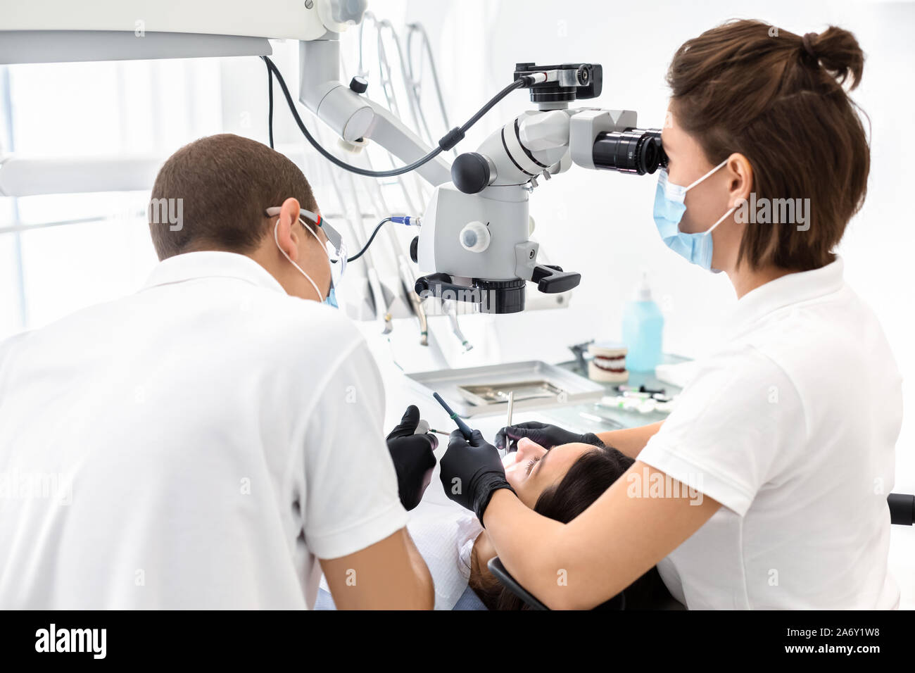 Two dentists making treatment in modern dental clinic Stock Photo
