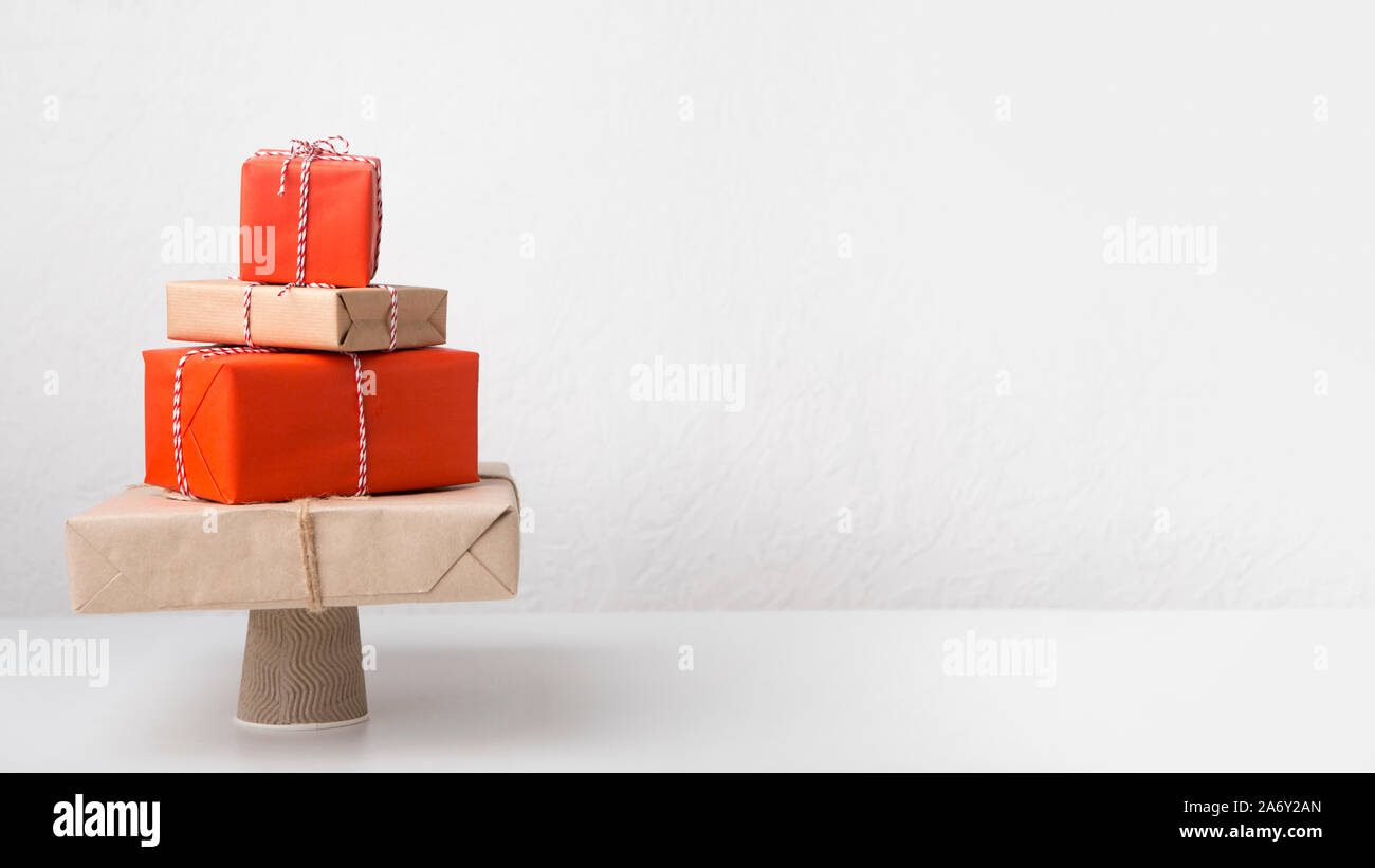 Big pile of creative wrapped presents in shape of Christmas tree Stock Photo