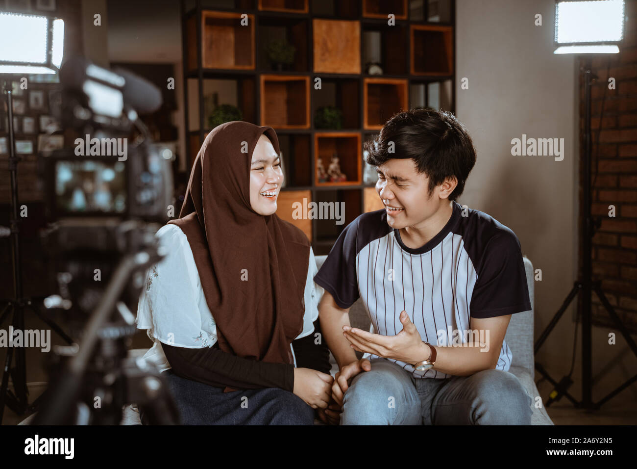 Asian muslim couple blogger recording vlog talking to camera Stock Photo