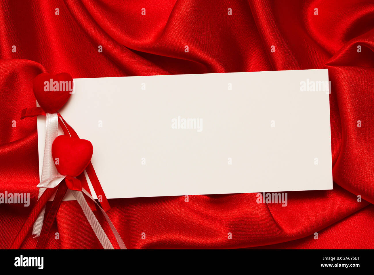 White card for congratulation on a background from red silk Stock Photo