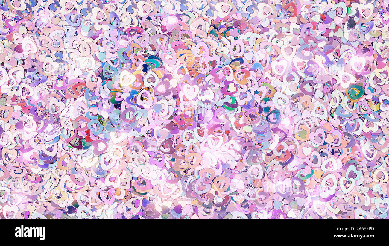 Real shiny heart-shaped sparkles textured background Stock Photo
