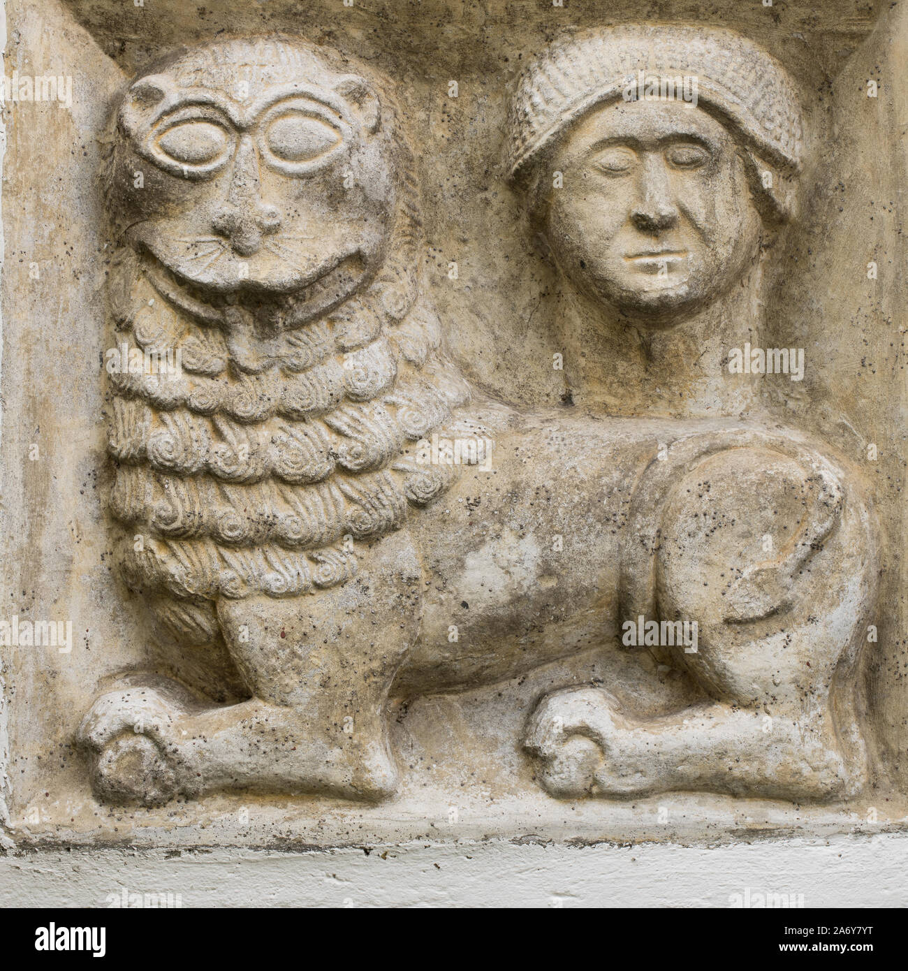 ancient greco roman relief of mythical lion and human head build into wall Stock Photo