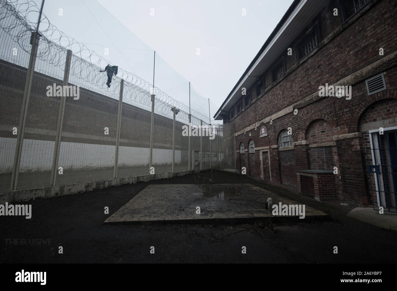 GLOUCESTER: The eerie courtyard. EERIE photos of the UK’s ‘most haunted’ prison where serial killer Fred West was locked up capture the facility’s dar Stock Photo