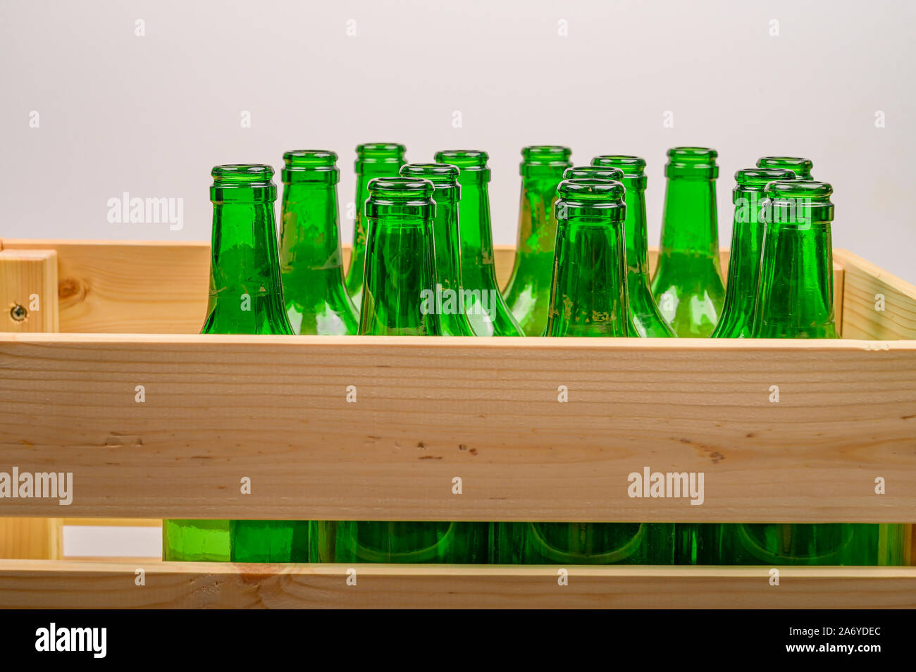 Empty wine bottles in a wooden box on the table. Home winemaking Stock Photo