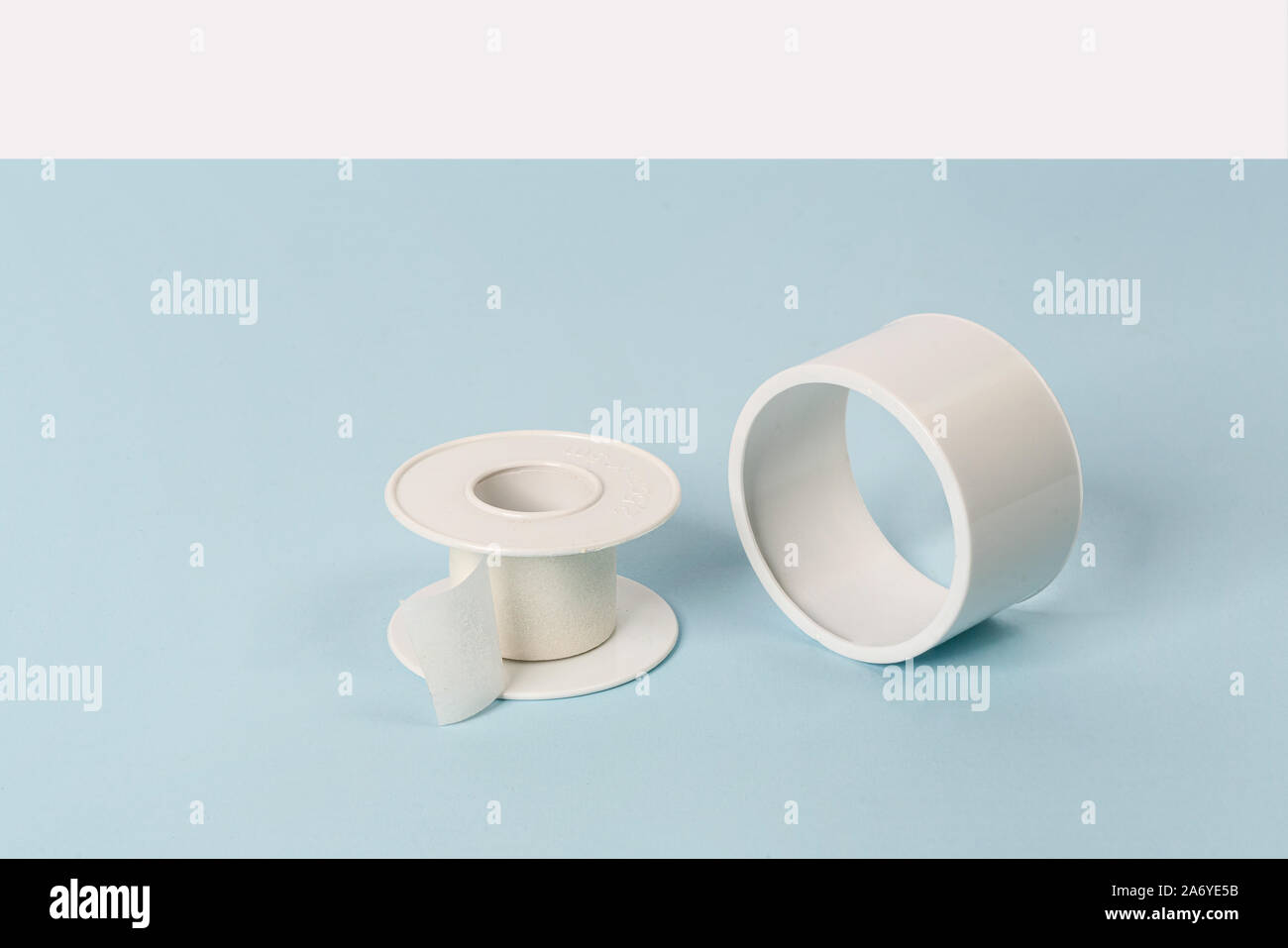 a. roll of white paper adhesive tape on a colored surface Stock Photo