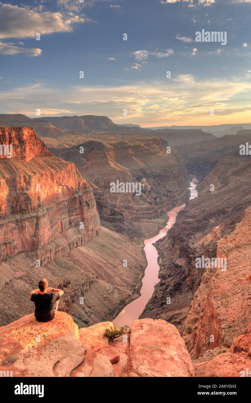 USA, Arizona, Grand Canyon National Park (North Rim), Toroweap (Tuweep) Overlook, Hiker on cliff edge (MR) Stock Photo