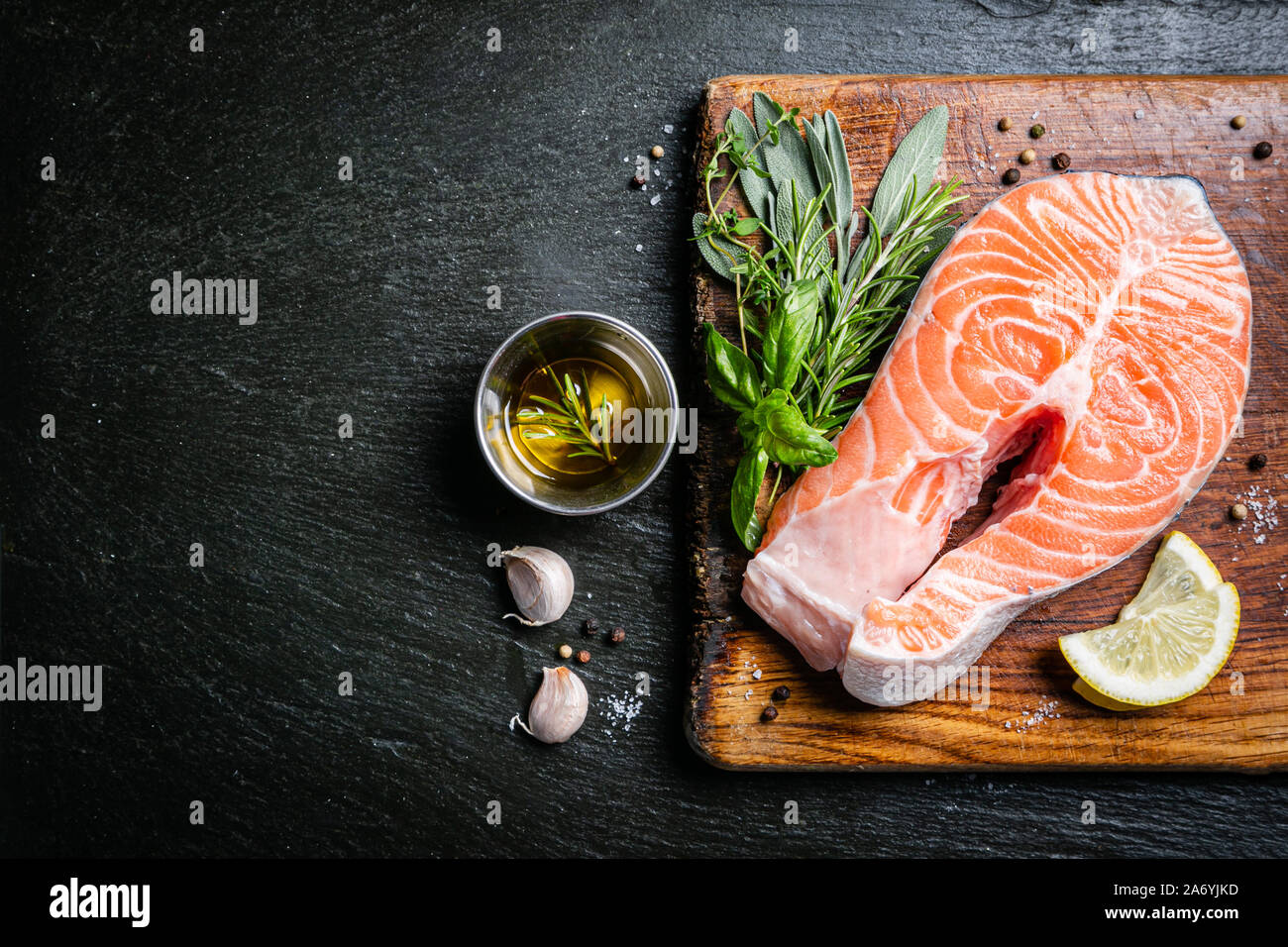 Raw salmon with herbs and spices, rustic background Stock Photo - Alamy