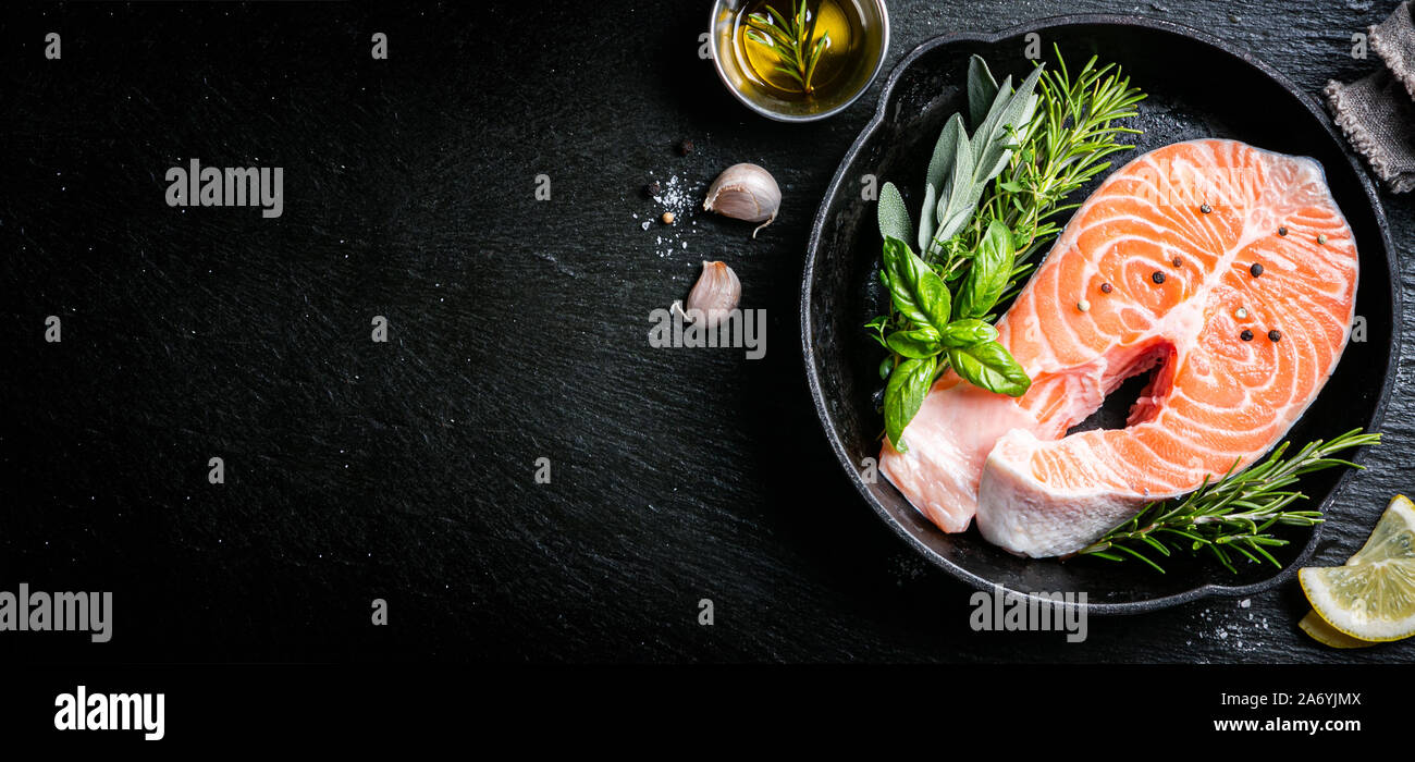 Raw salmon with herbs and spices, rustic background Stock Photo - Alamy