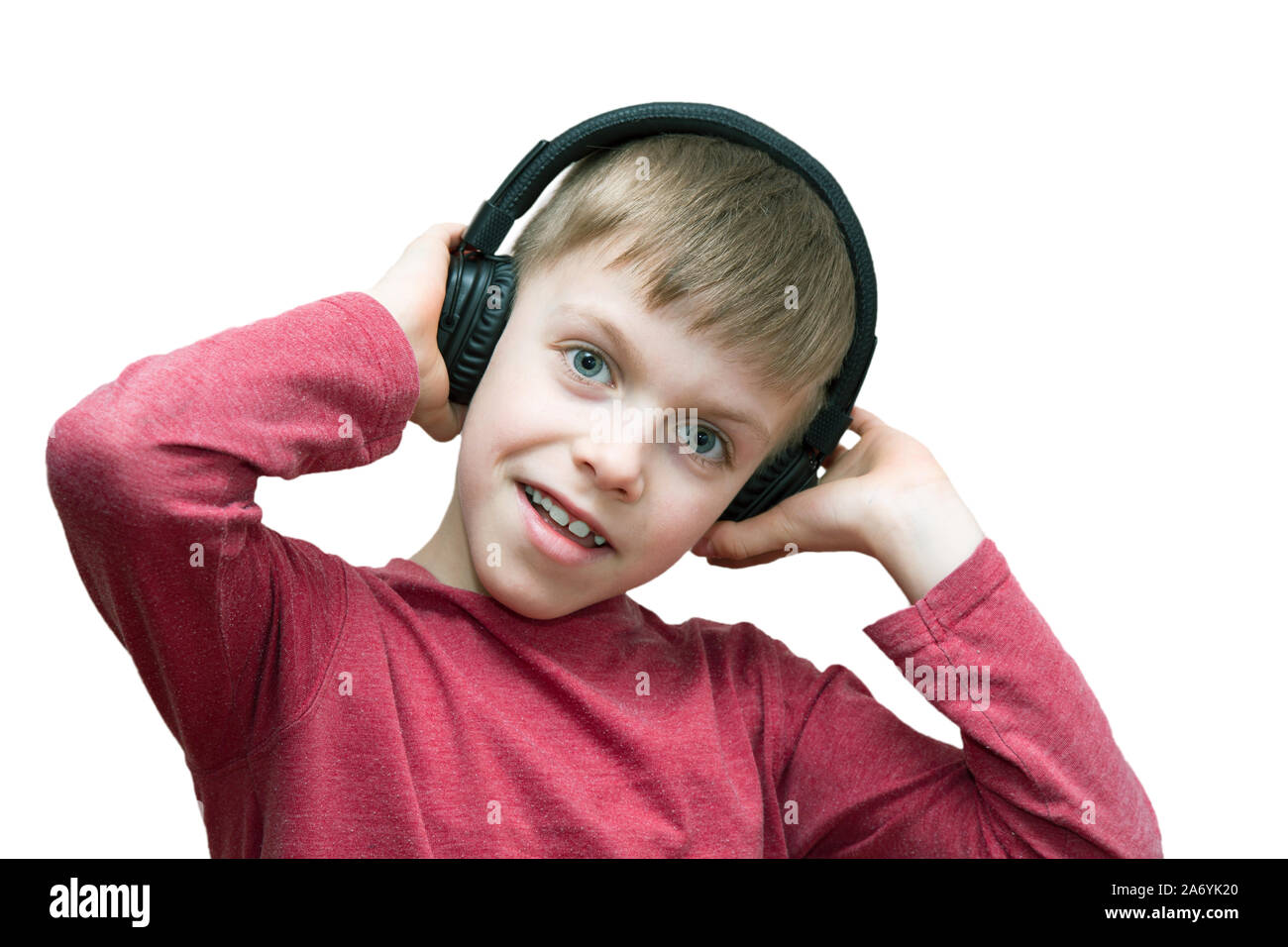 seven year old boy with headphones singing on white background Stock Photo