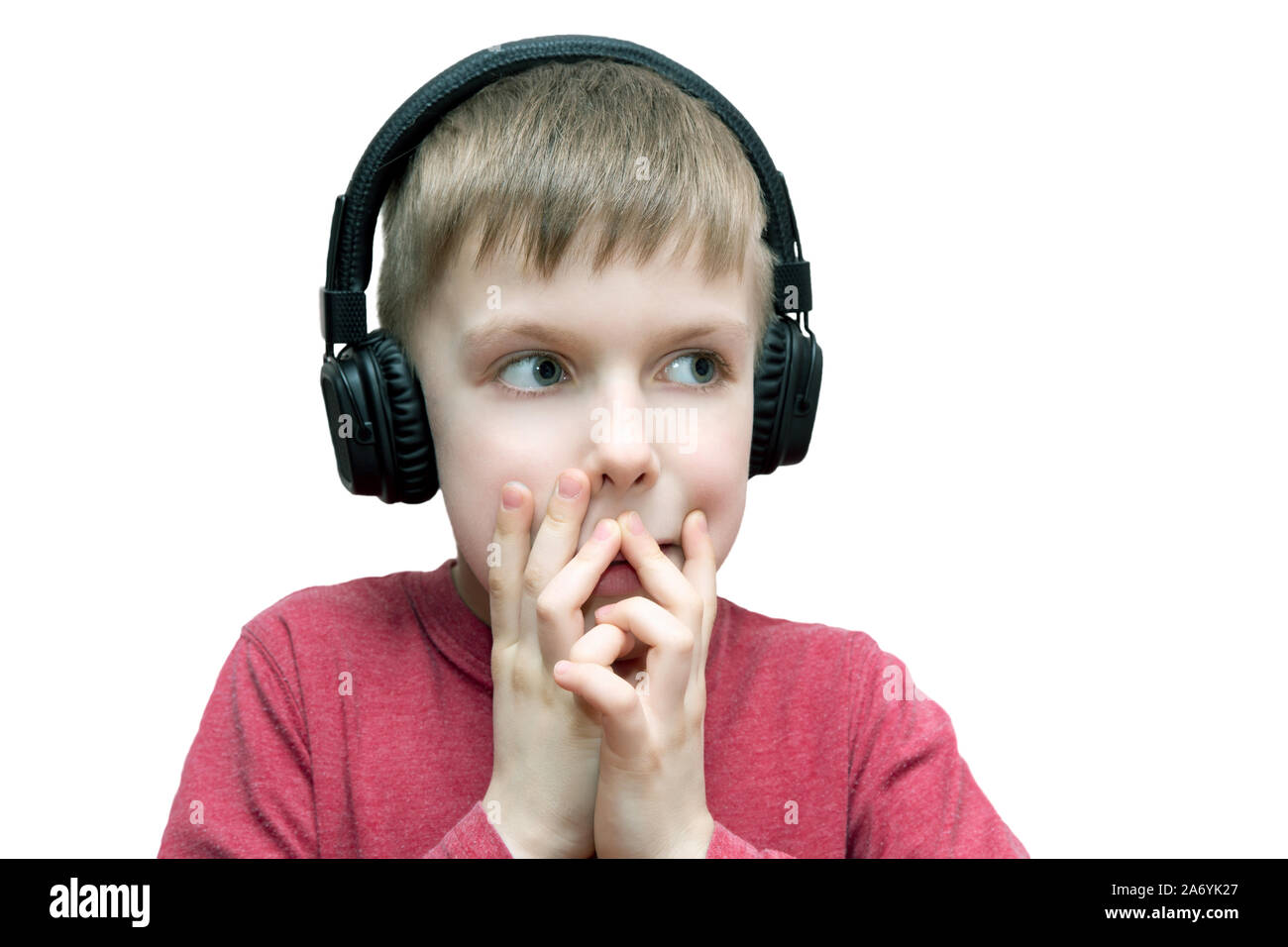 seven year old boy with headphones singing on white background Stock Photo