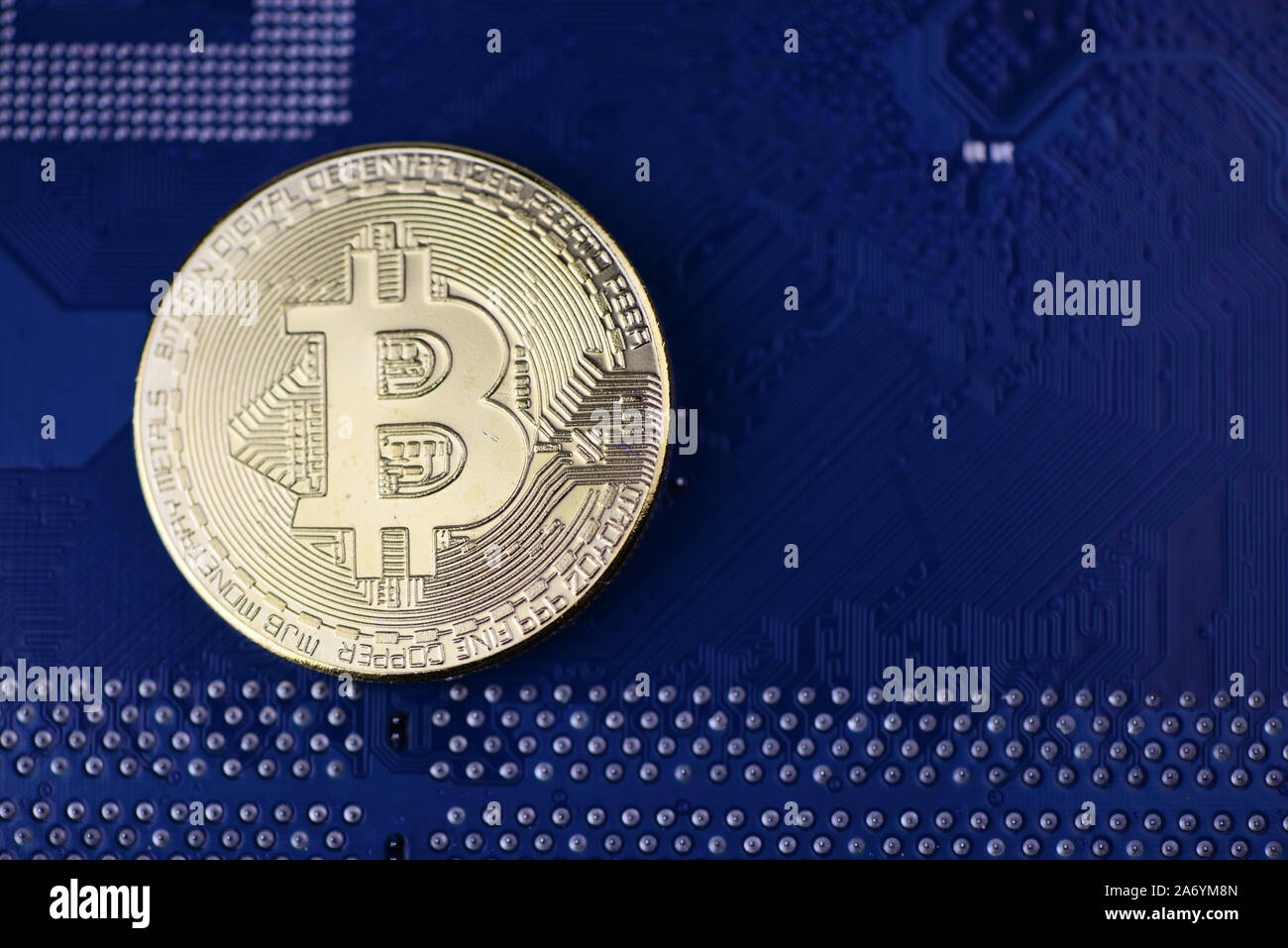 Golden Cryptocurrency coins on computer circuit board - image Stock Photo