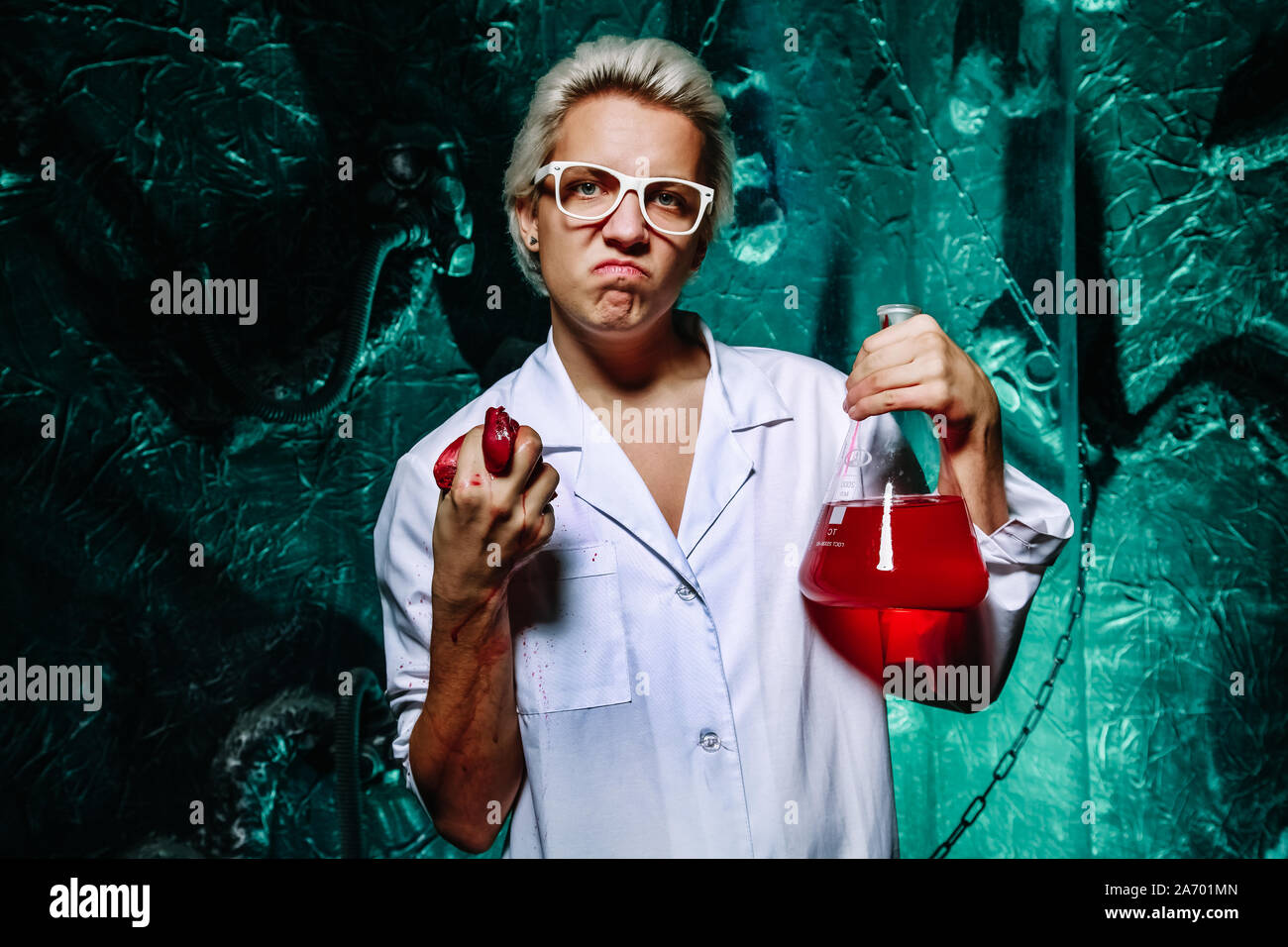 mad medical scientist in doctor’s robe eats raw meat and enjoys