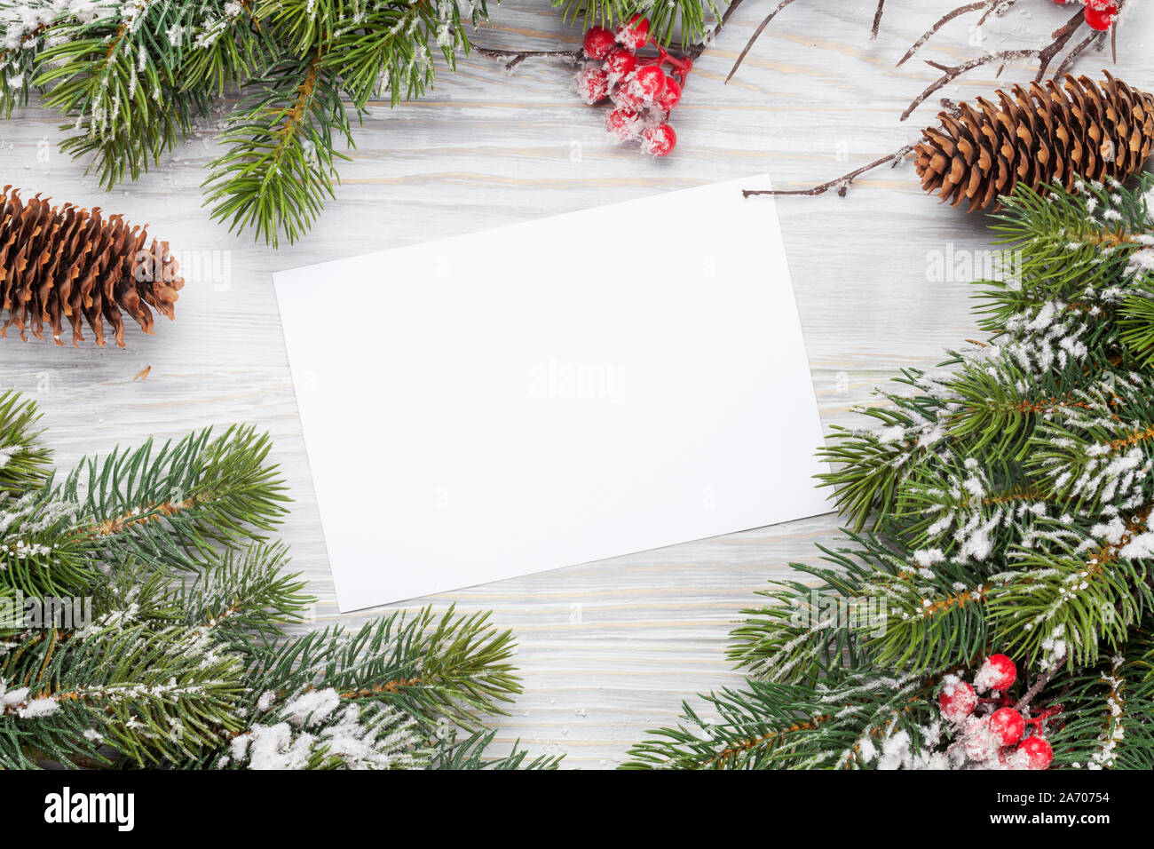 Christmas greeting card and fir tree branch over wooden texture ...
