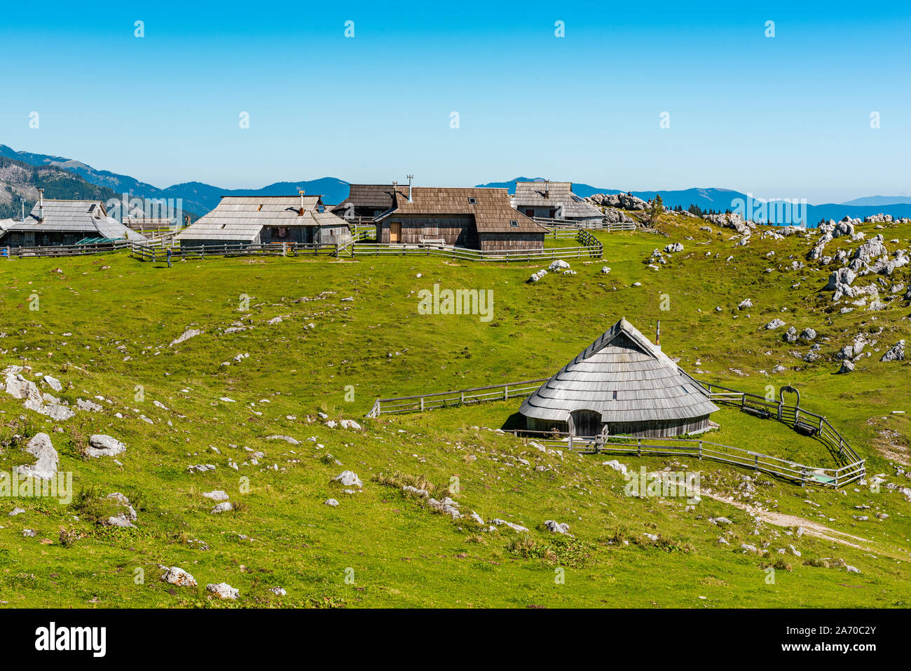 Big Pasture Plateau or Velika Planina in Slovenia. traditional Wooden Shepherd Shelters in Mountains. Stock Photo