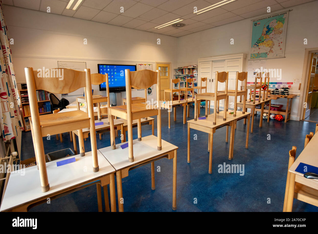 Empty schoolclass of an elementary school with chairs on the tables Stock Photo