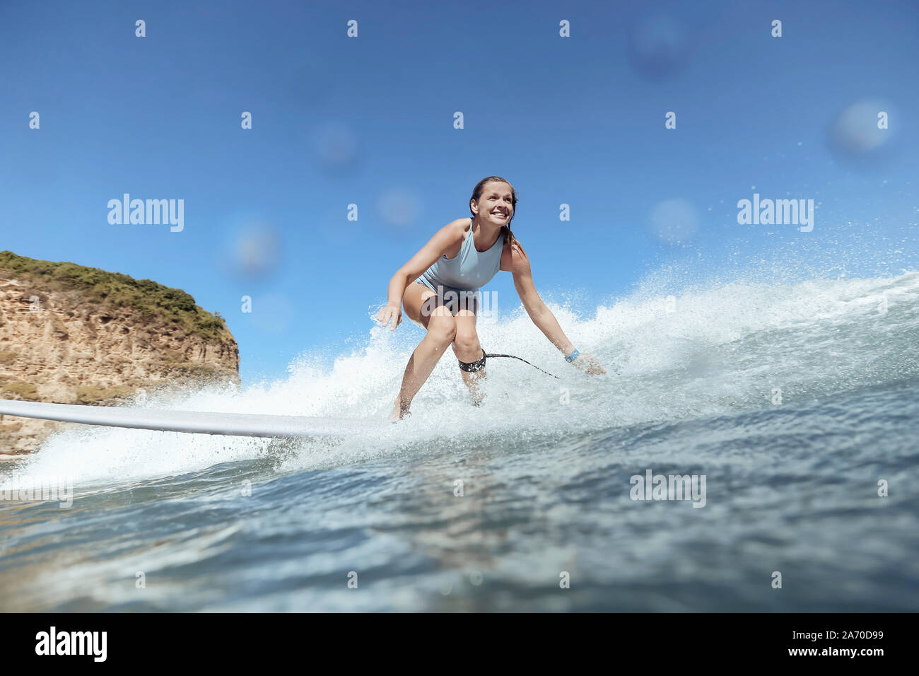 Smiling woman surfing Stock Photo