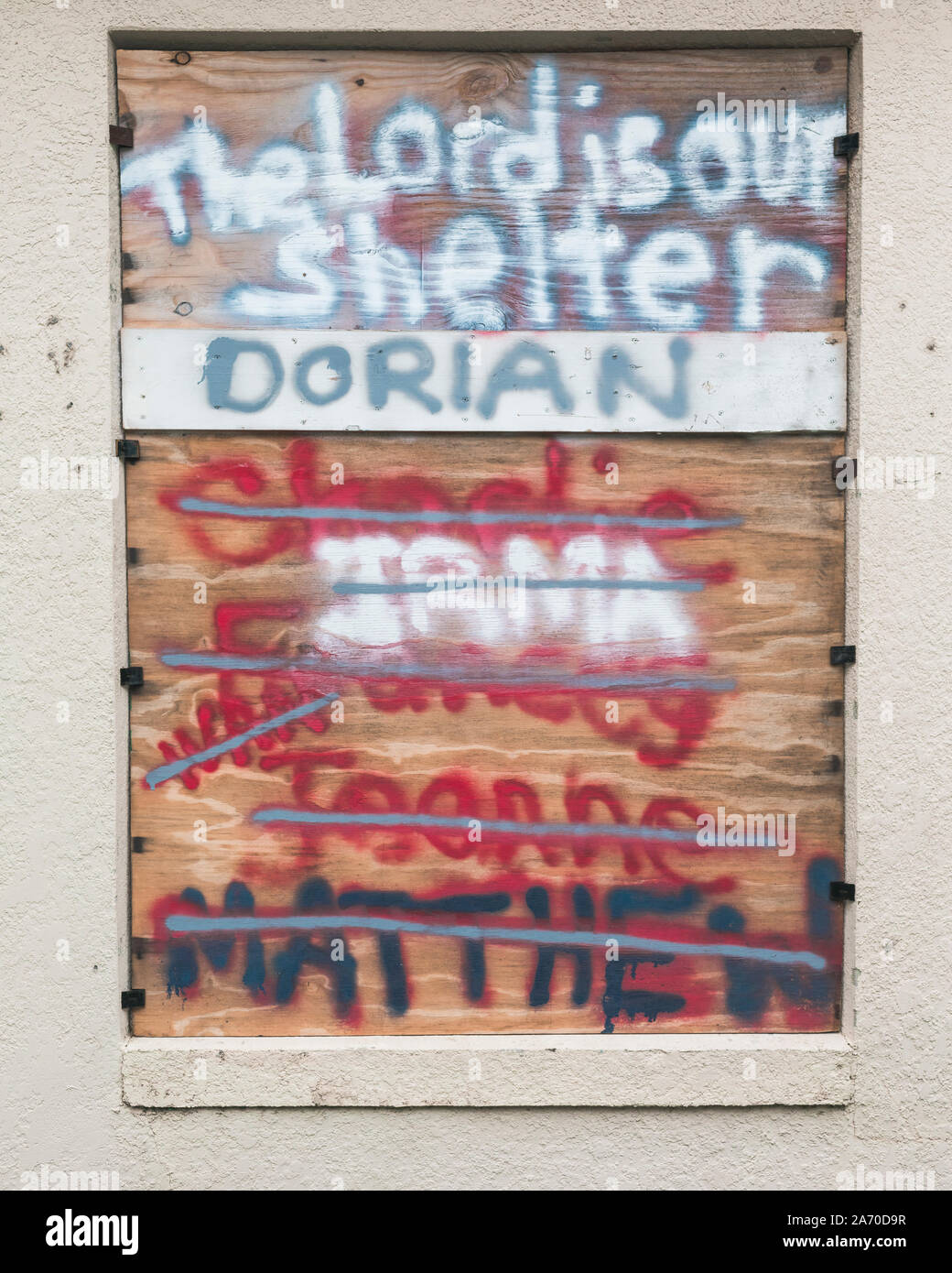 Boarded window for hurricane with names of past hurricanes painted Stock Photo