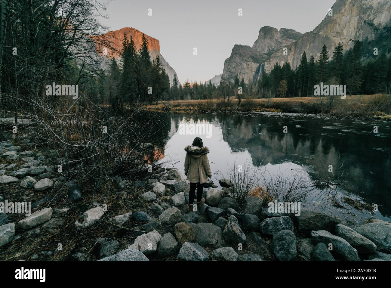 Female tourist in Yosemite looking at river against mountains Stock Photo