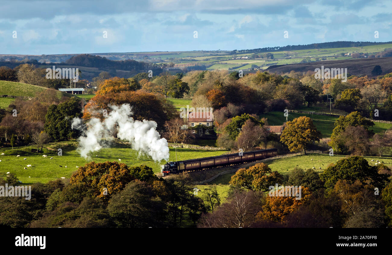 An LMS 5428 locomotive travels through an autumn scene along North Yorkshire Moors Railway in the North York Moors National Park. Stock Photo