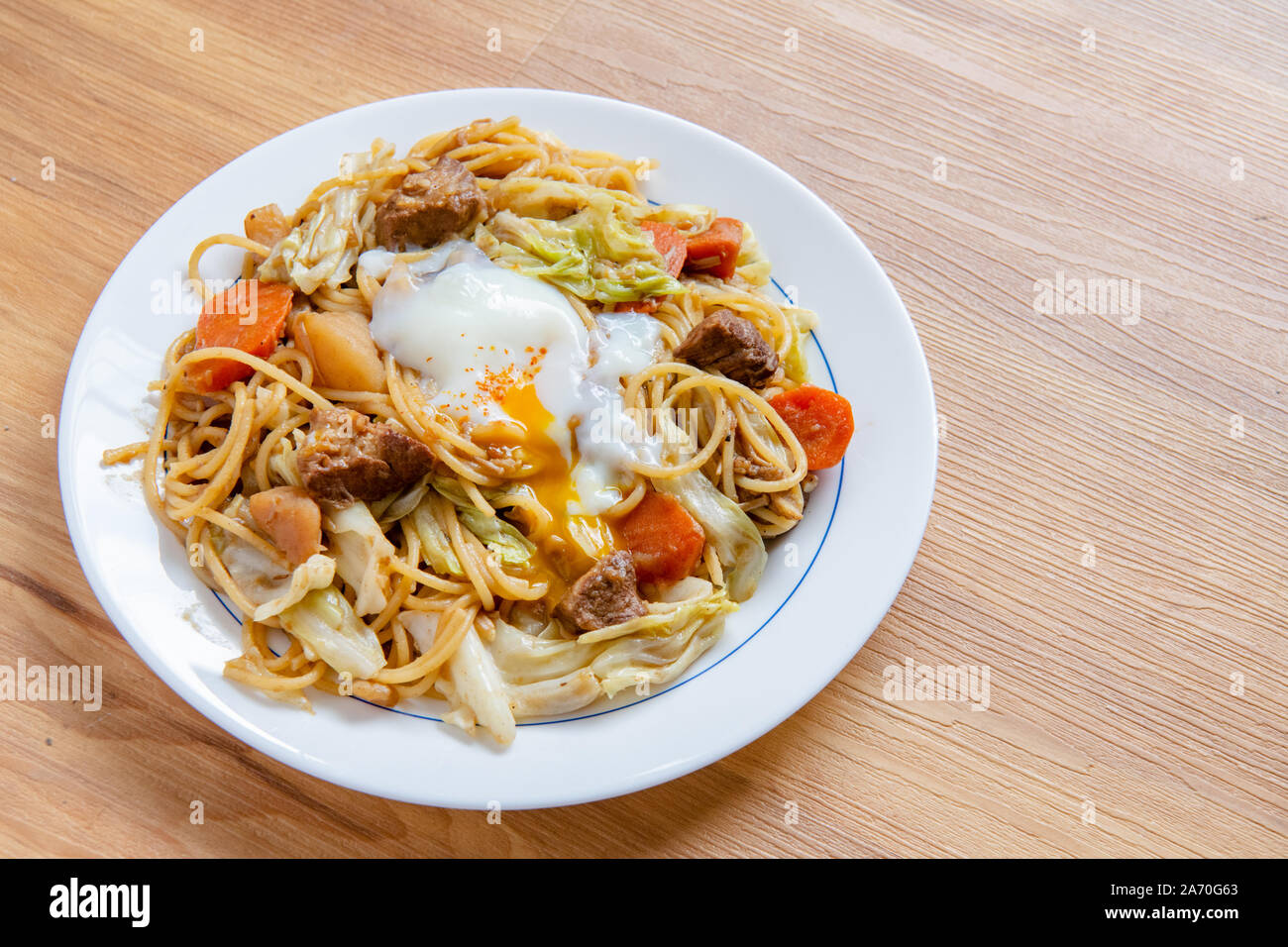 Pork Curry spaghetti  on wooden background ( Onsen tamago, Potato, enoki mushroom, onion, broccoli, Japanese style,) Stock Photo