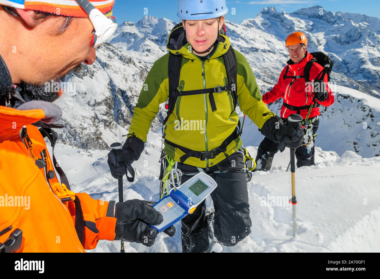 Mountain guide checking functionality of safety equipment Stock Photo