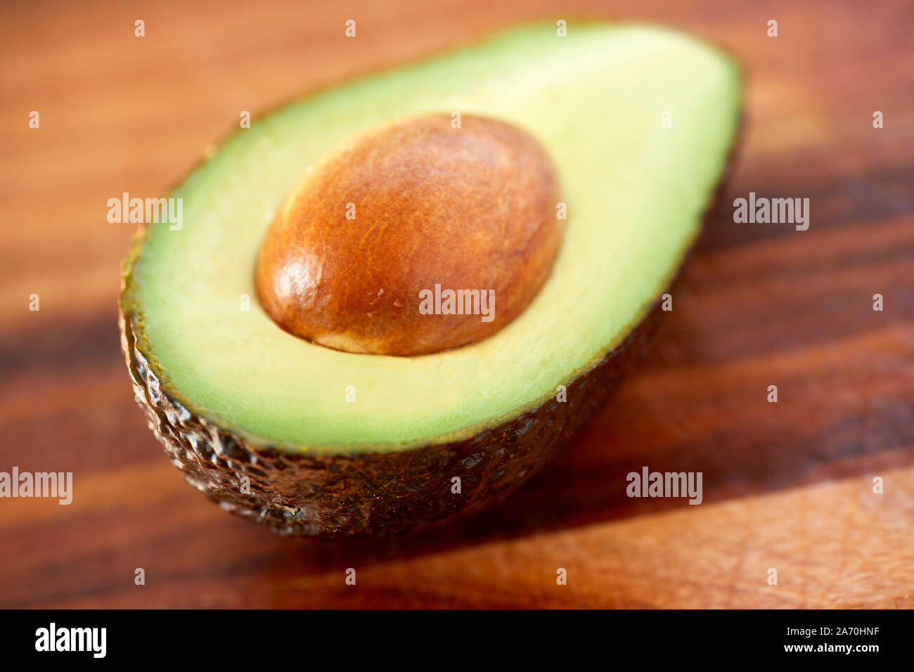 Avocado on chopping board Stock Photo
