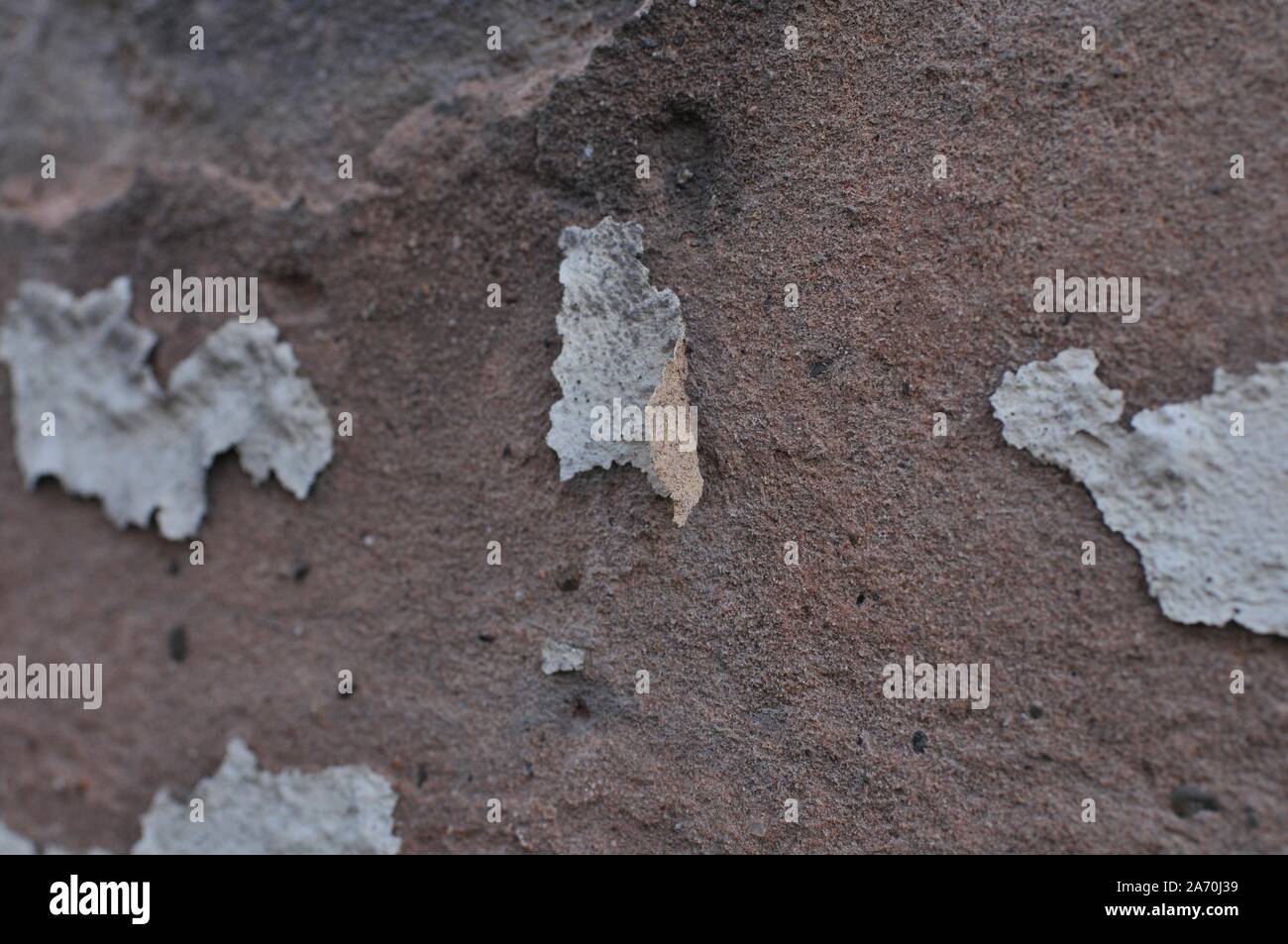 Cracked Broken Destroyed Weathered Plaster Paint on Exterior White Wall Stock Photo