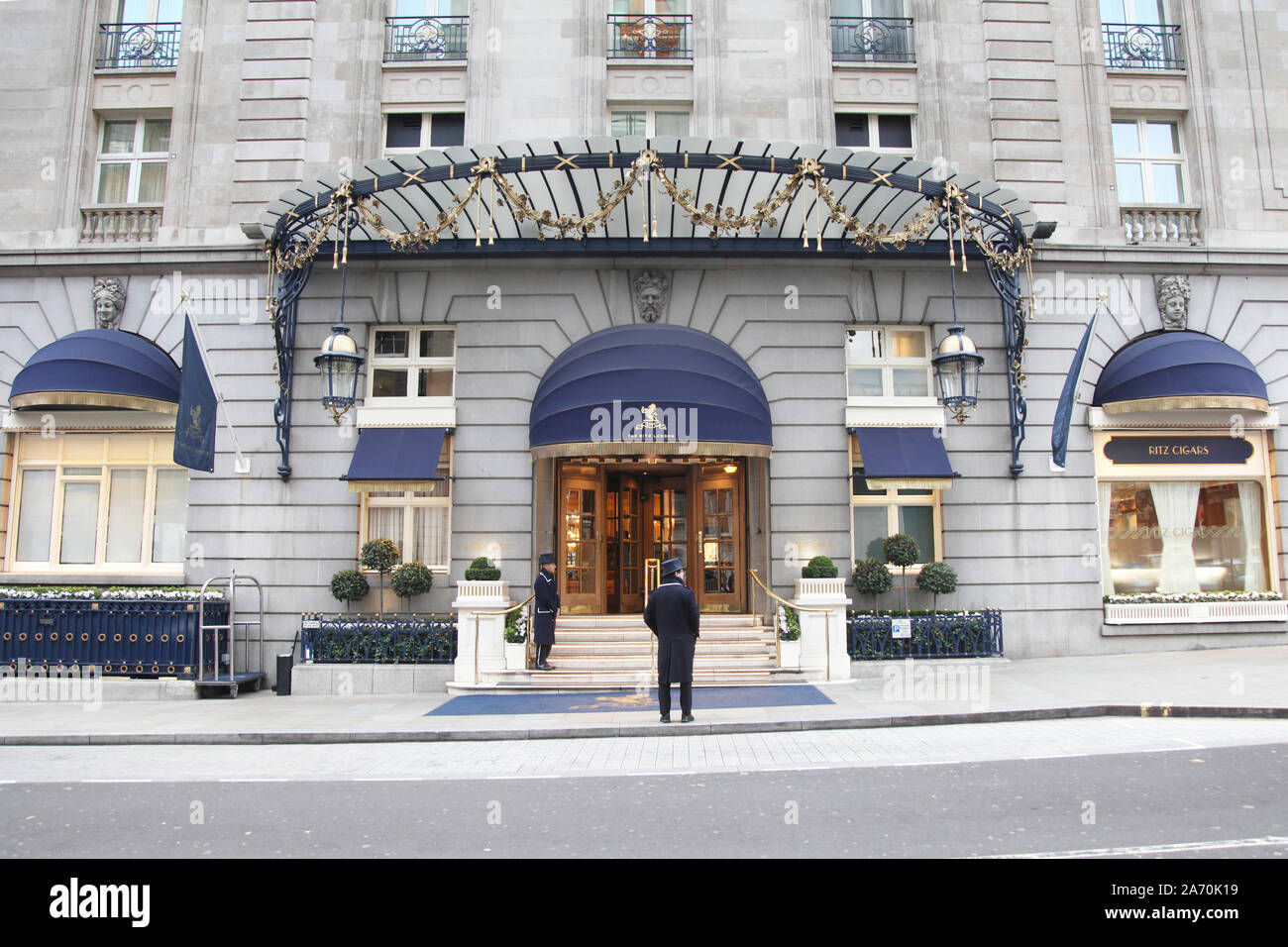Entrance to The Ritz Hotel on Arlington Street, Mayfair, London with two doormen standing outside, wide shot, daytime Stock Photo
