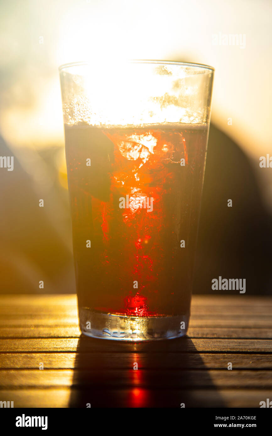 Red wine against the sun with male silhouette at background Stock Photo