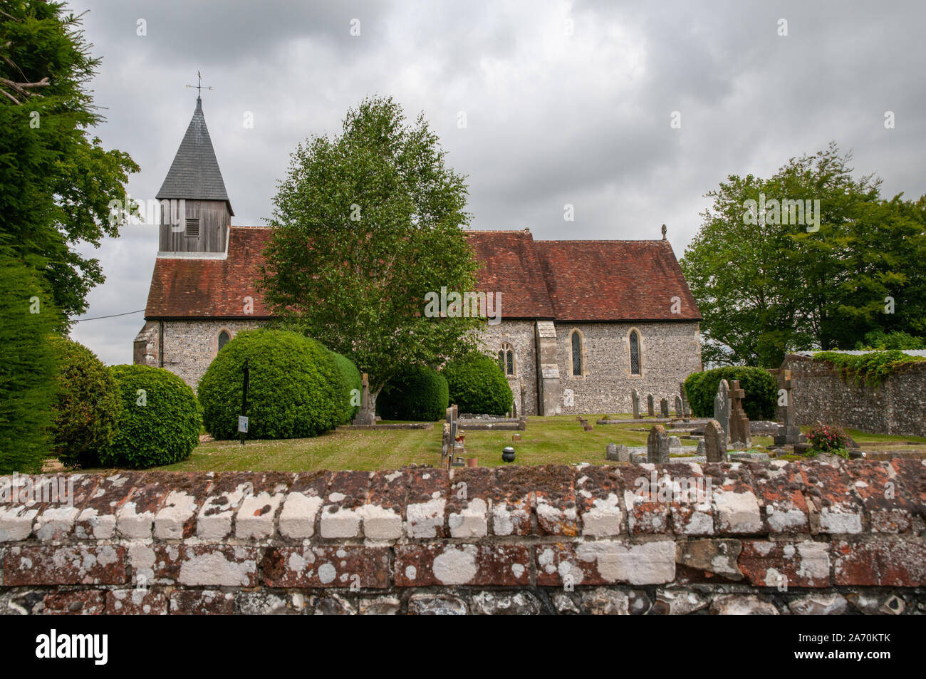 St Peter and St Paul church and graveyard in Exton village in Hampshire, England. Stock Photo