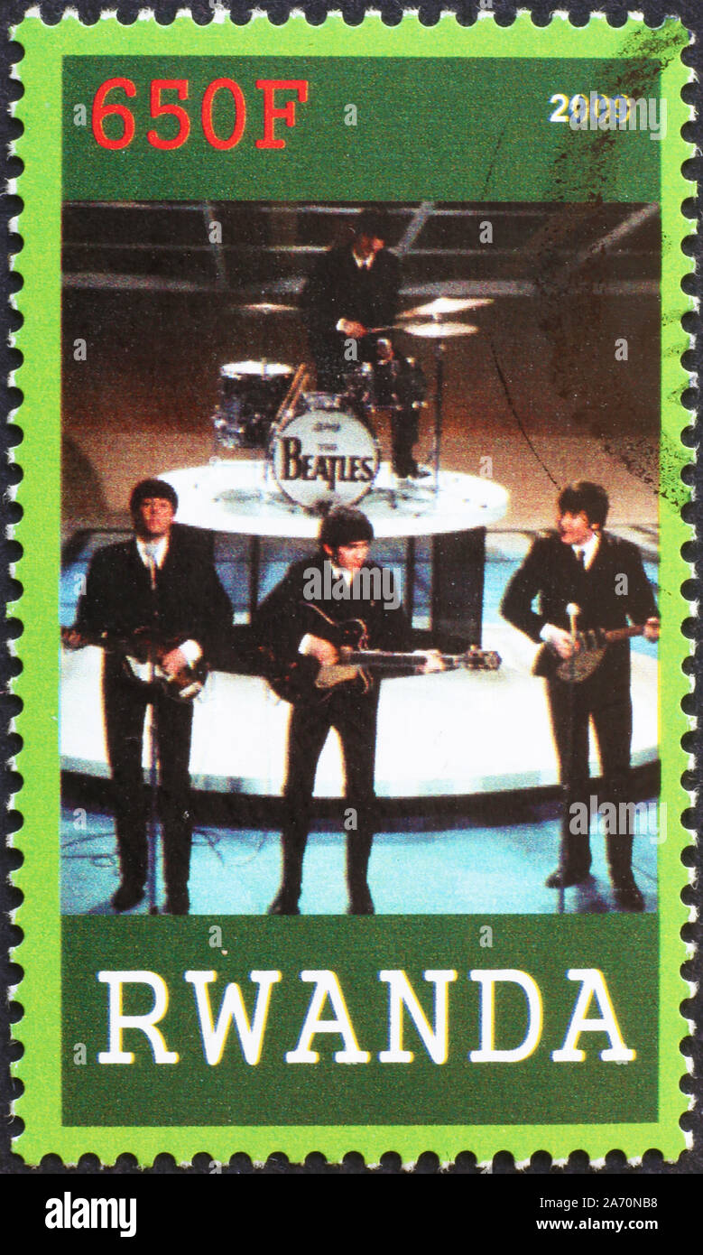 The Beatles playing on postage stamp of Rwanda Stock Photo