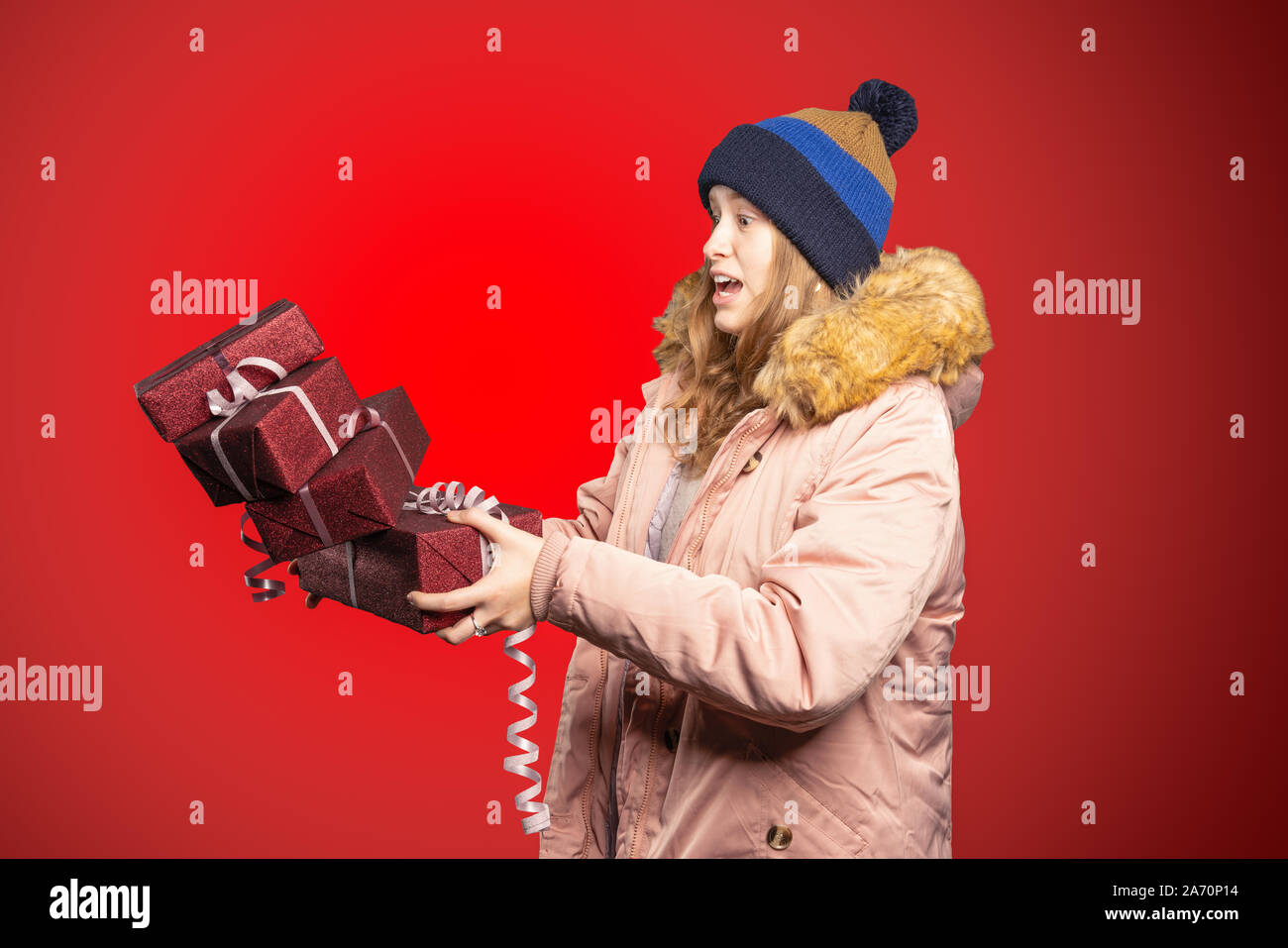 A young woman drops a pile of presents while walking Stock Photo - Alamy