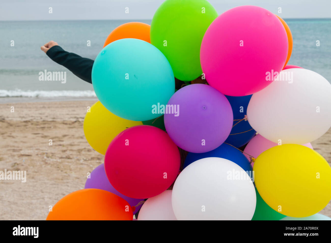 Woman posing with colorful balloons on the beach Stock Photo - Alamy