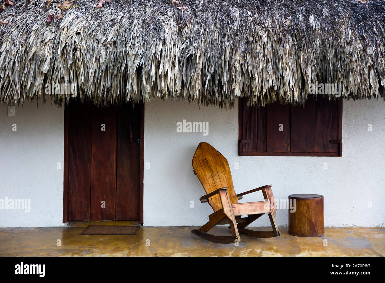 Old wooden rocking chair by the old house at Caribbean sea in Santa Marta, Colombia Stock Photo