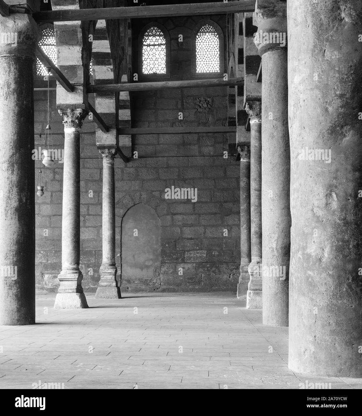 Black and white shot of corridor surrounding the courtyard of public historical Mosque of al Sultan al Nasir Muhammad Ibn Qalawun situated in the Citadel of Cairo, Egypt Stock Photo